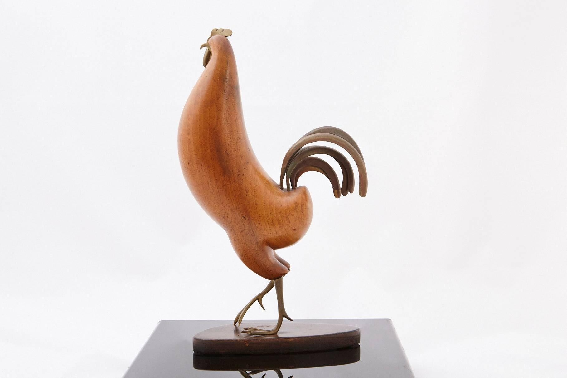 Elegant, streamlined, modernistic sculpture of a rooster by Karl Hagenauer of Vienna. The rooster's tail, feet and comb are crafted from bronze, the body hand-carved from walnut, all raised on a tinted walnut base.
Hagenauer has finely captured the