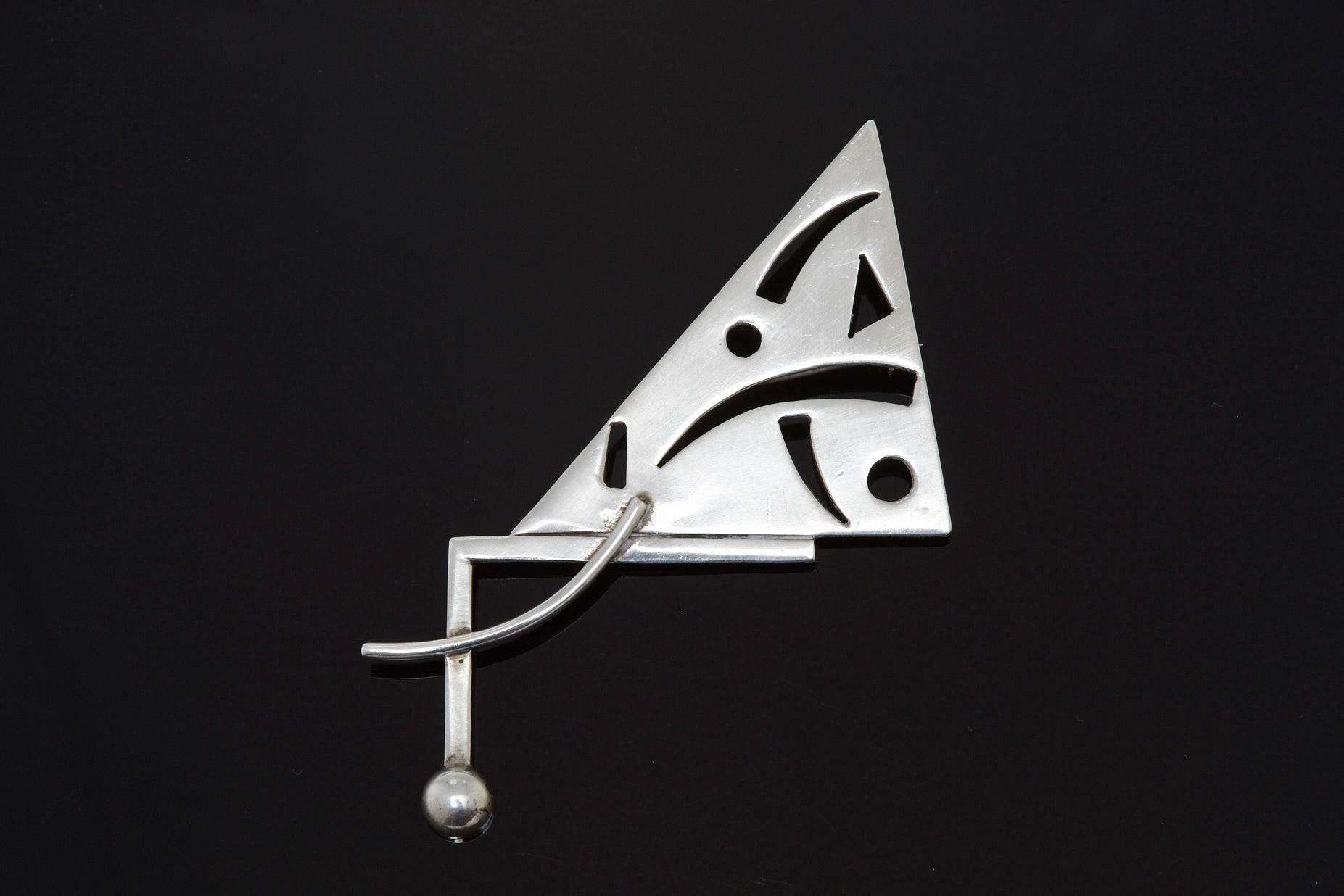 Abstract Mexican Sterling Silver Brooch, hallmarked 925 Mexico TC-105.

In 1980 Mexico silversmiths initiated a letter and number system to register silversmiths. The first letter indicates the city and the second letter is the first letter of the