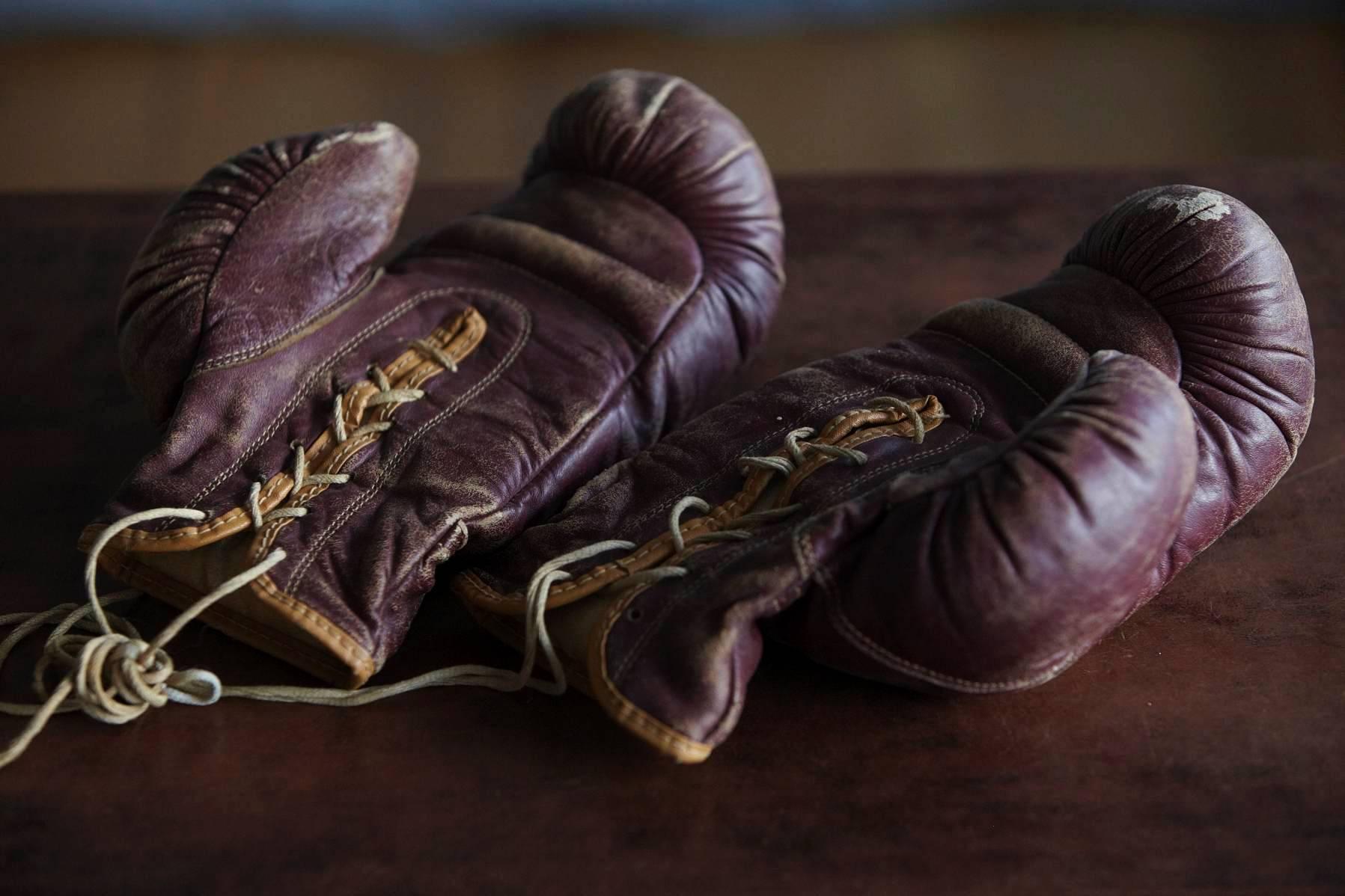 Great pair of 1930s hand stitched boxing gloves made by George A. Reach sporting goods Company.
Beautiful dark maroon leather trimmed with brown edges and a nice patina. 
The gloves are of highest quality for that area, the leather remains soft