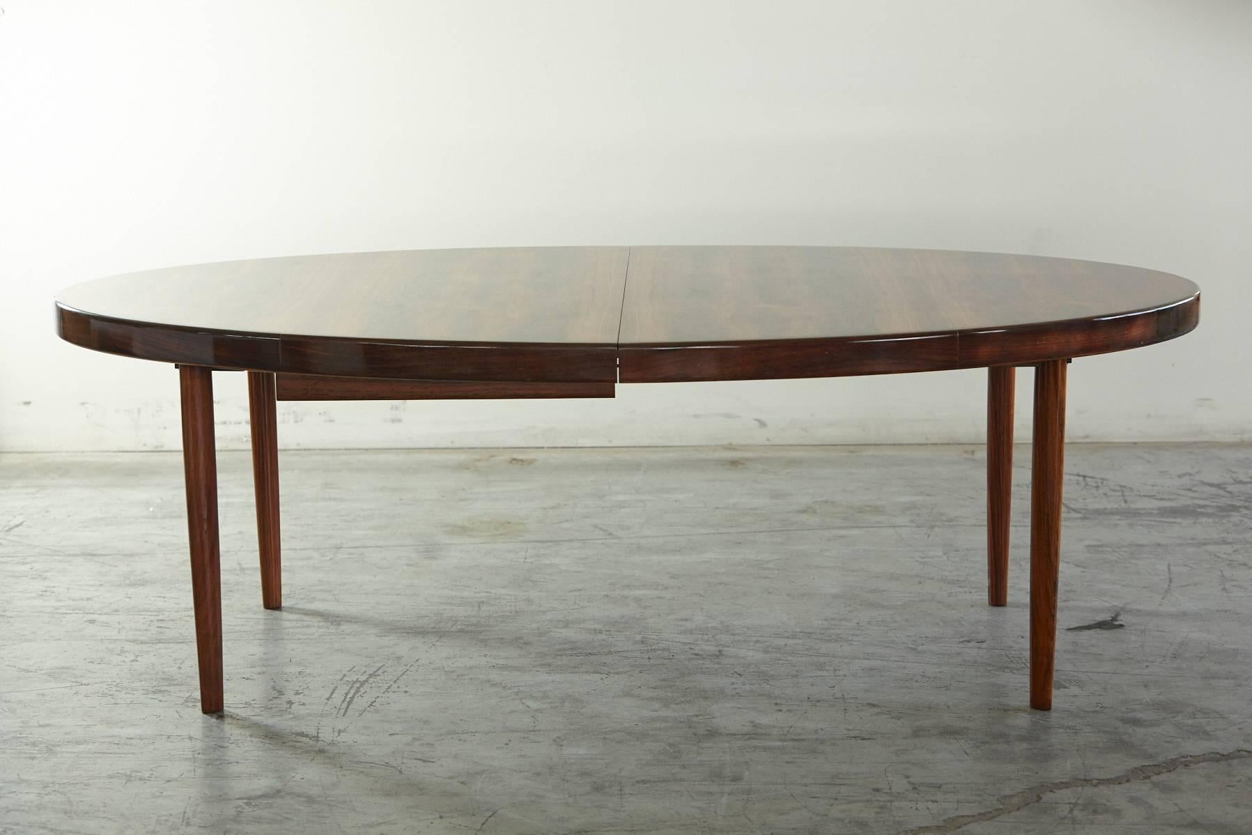 Truly rare and stunning rosewood table. Extremely functional with butterfly extension in the center, making it very sizeable and creating an impressive look.
Width fully extended with two leafs 107.5