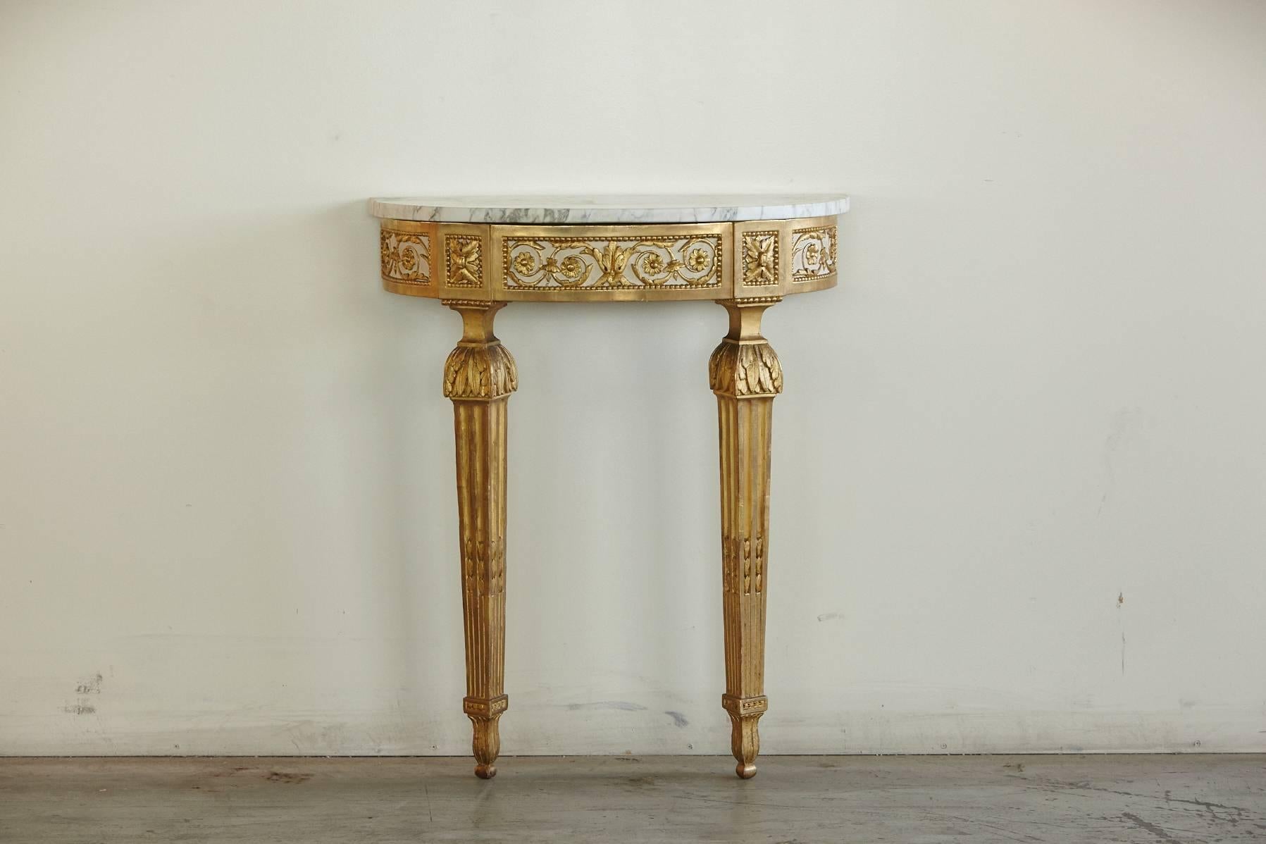 Very fine example of a Louis XVI style console with a beautifully carved gold leaf apron. The Carrara marble top is in excellent condition, circa 1870.