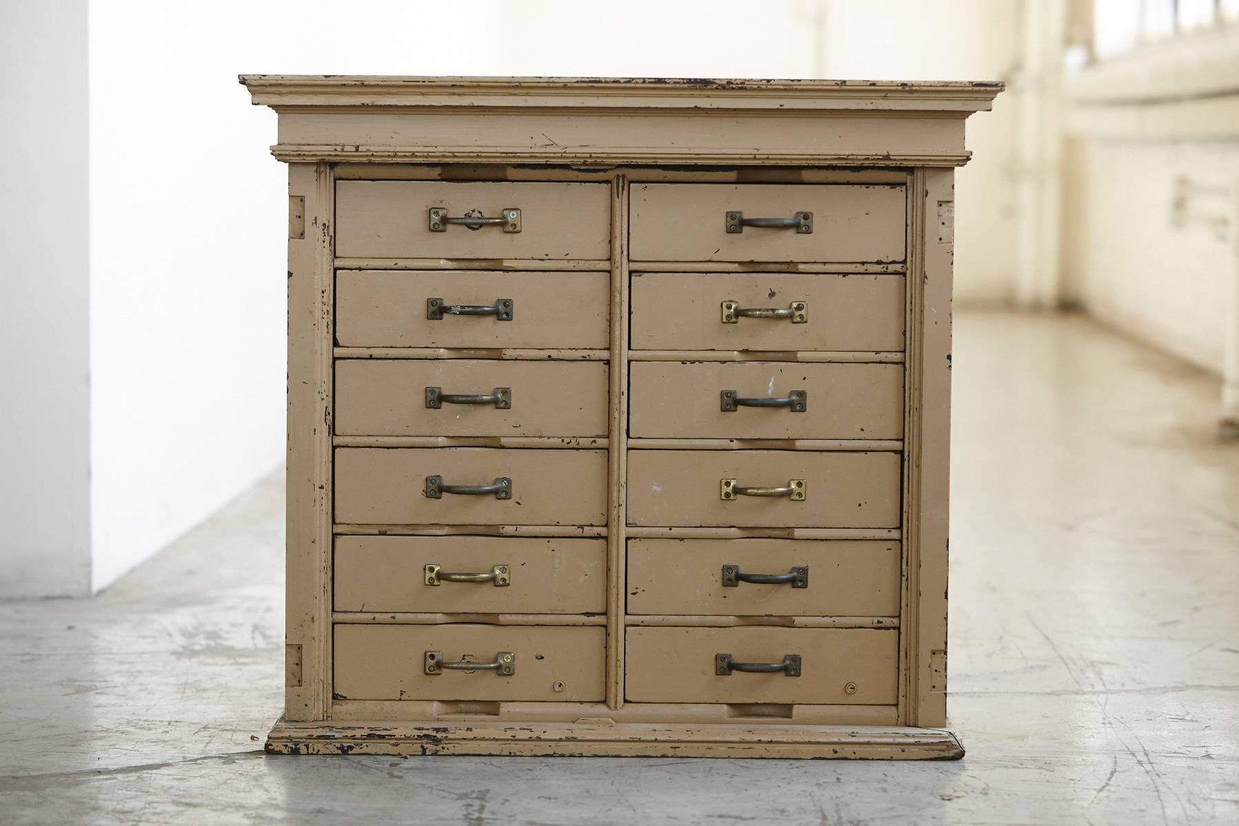 Original paint 12-drawer cabinet with metal pulls. Nice original distressed appearance. Some of the metal pulls have been replaced, all 12 drawers open and close easily.