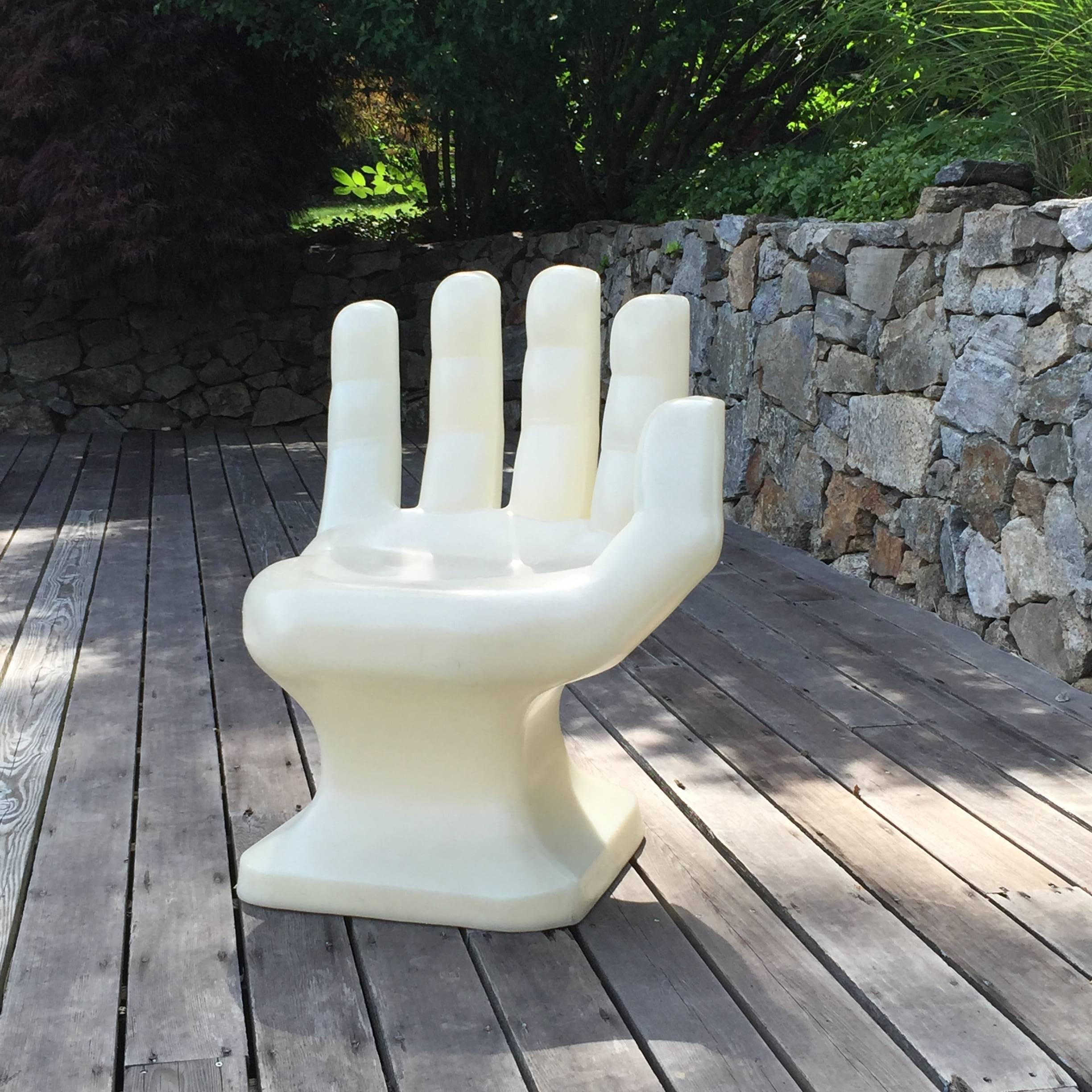 Cool looking oversized, white hard plastic (resin) chair in form of a hand. 
Nice sculptural, molded chair form the Pop Art area, circa 1970s.