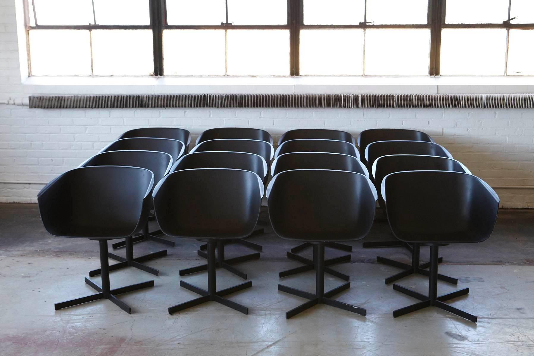 Set of 16 black 'shell' inspired polyurethane chairs by the Italian designer Carlo Colombo for Poliform, raised on a revolving four star base.
The chairs have some signs of cosmetic wear, but they are fully operational and sturdy.