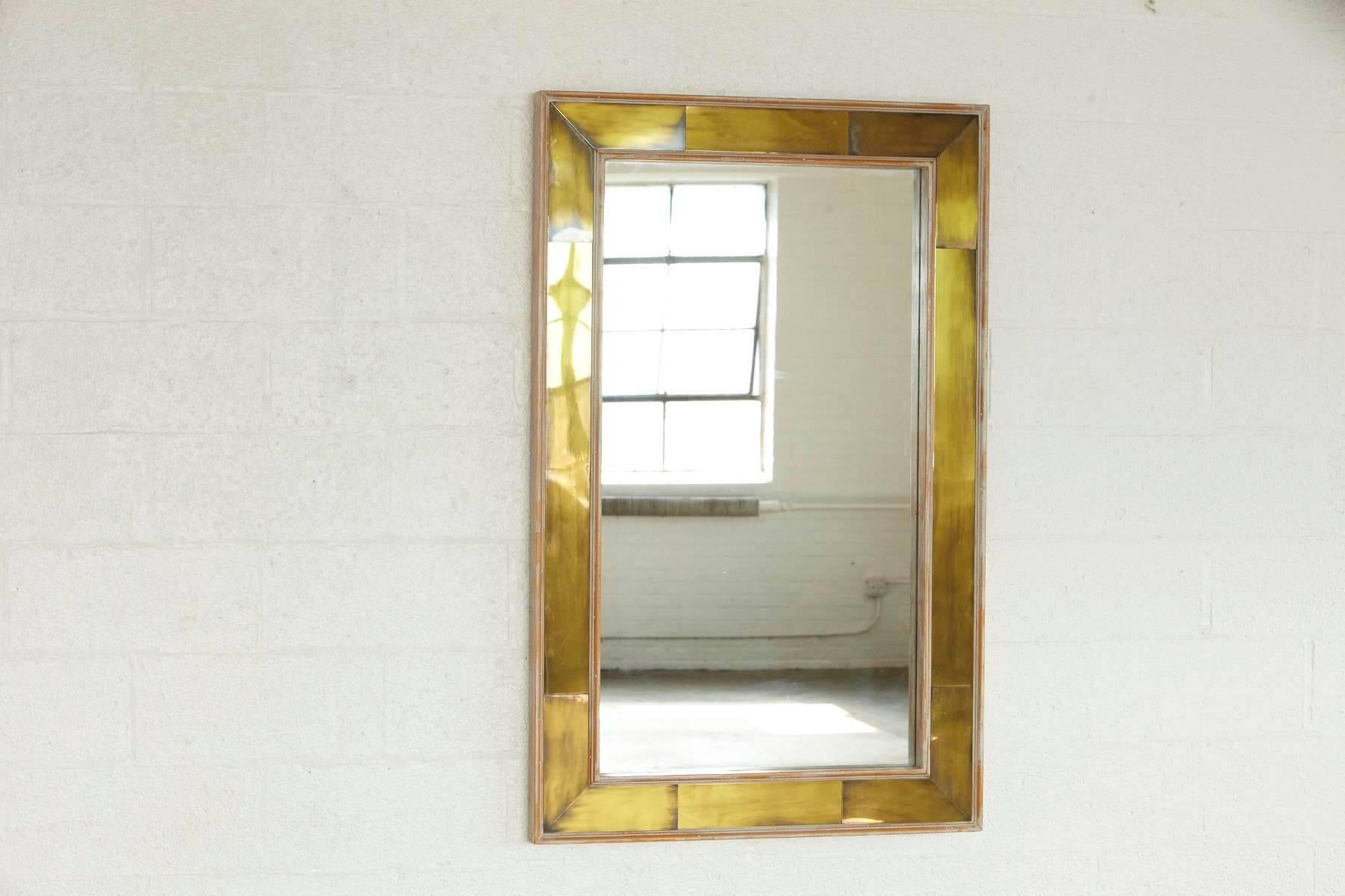 Stylish rectangular, modern wall mirror with polished brass inlays in a white washed wood frame.