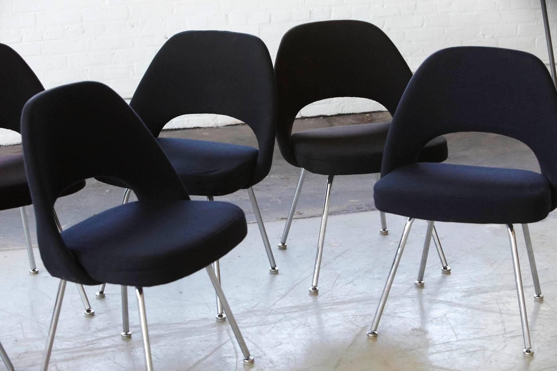 Beautiful set of six black Eero Saarinen executive armless side or dining chairs in black wool fabric with chrome legs. 
All chairs are in good condition except one, were the foam is a little firm,
but still in good shape.
Labeled on the bottom.