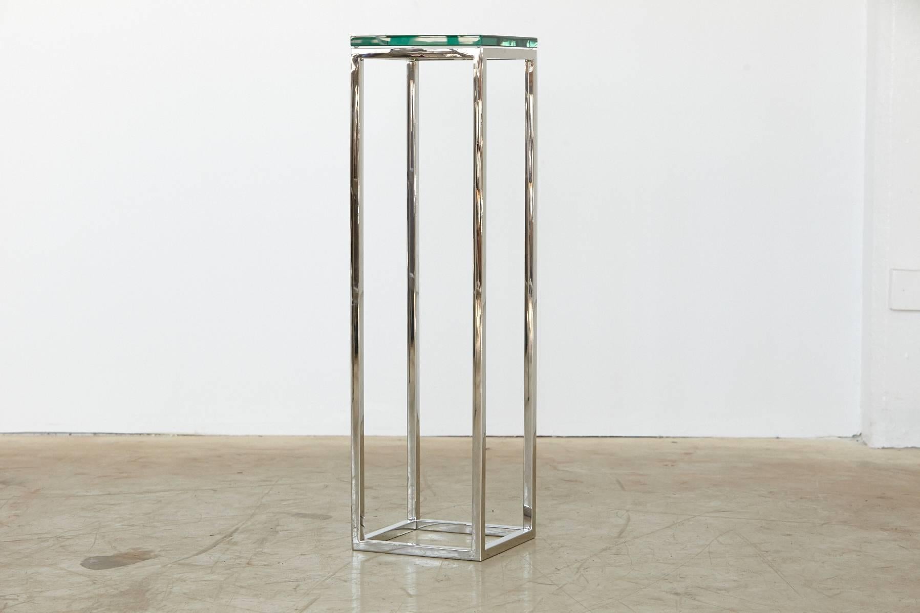 Tall square pedestal in polished chrome with thick glass top by Milo Baughman. 
The chrome and the glass top are in excellent condition.
No chips or fleabites in the glass.
