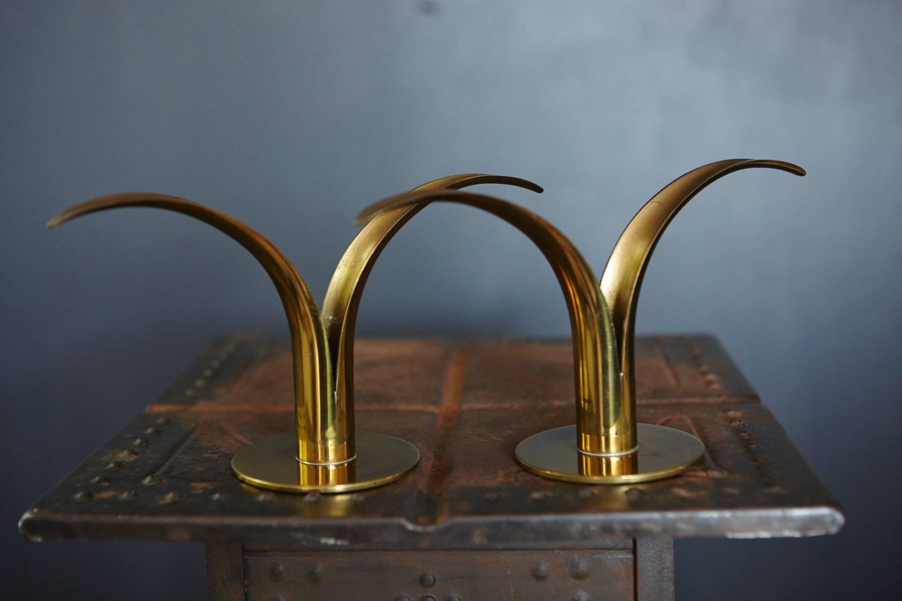 Original, beautiful patinated pair of brass 'Liljan' candleholders designed by Ivar Ålenius Björk, manufactured by Ystad Metal, Sweden. 
See engraved stamp on the bottom.