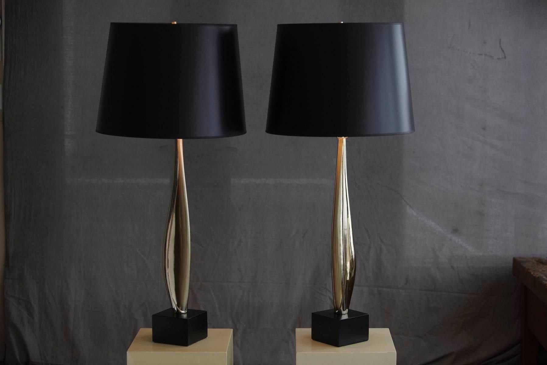 Pair of tall, sleek, sculptural chrome table lamps on a black lacquered base, attributed to Maurizio Tempestini.
The lamps come with brand new black shades.
Dimensions: Base 5" x 5" / Height to socket 27" / Height to finial 39"