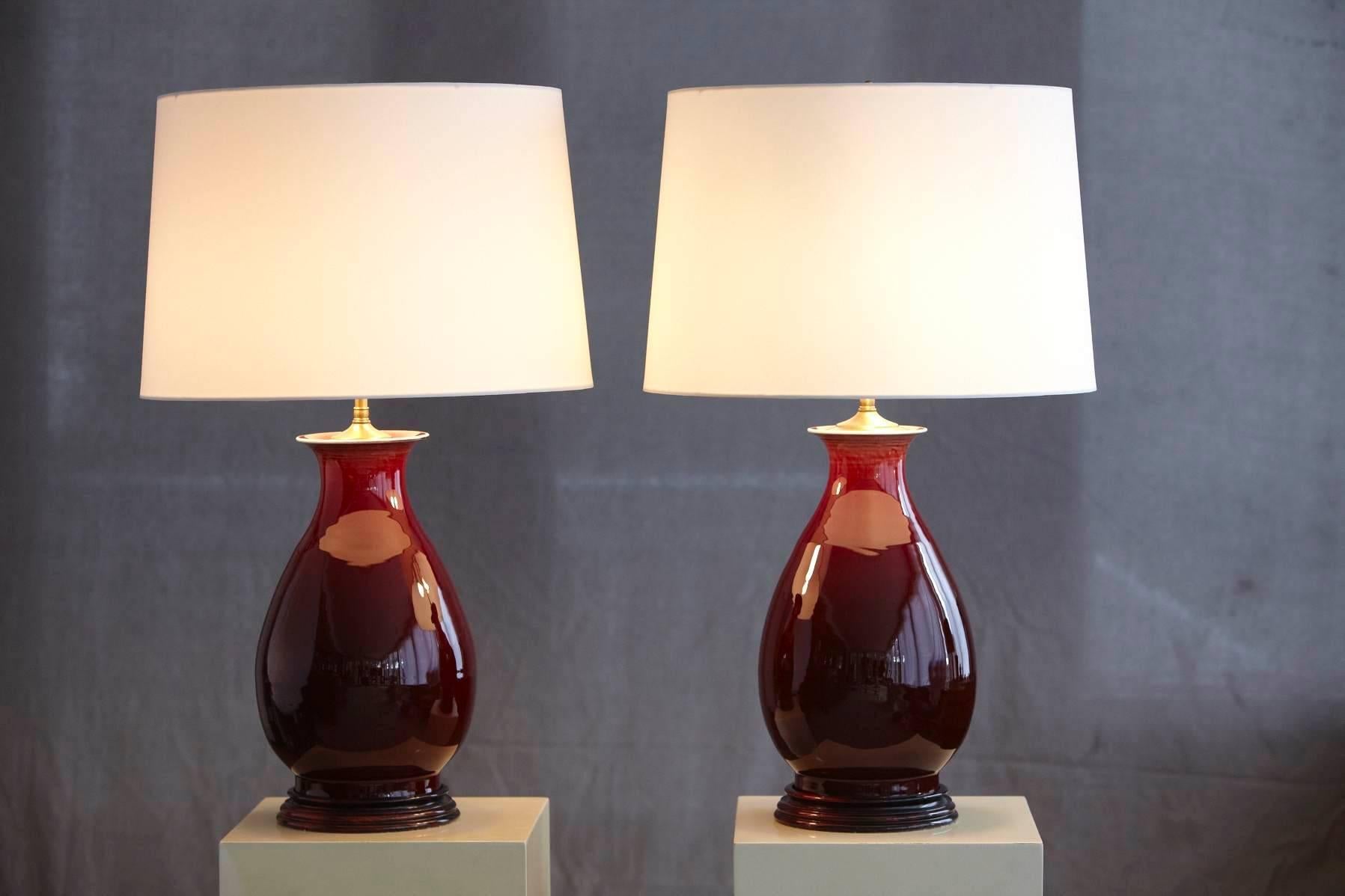 Mid-Century Modern Pair of Deep Red Glazed Ceramic Lamps with New Ivory Shades, Height Adjustable