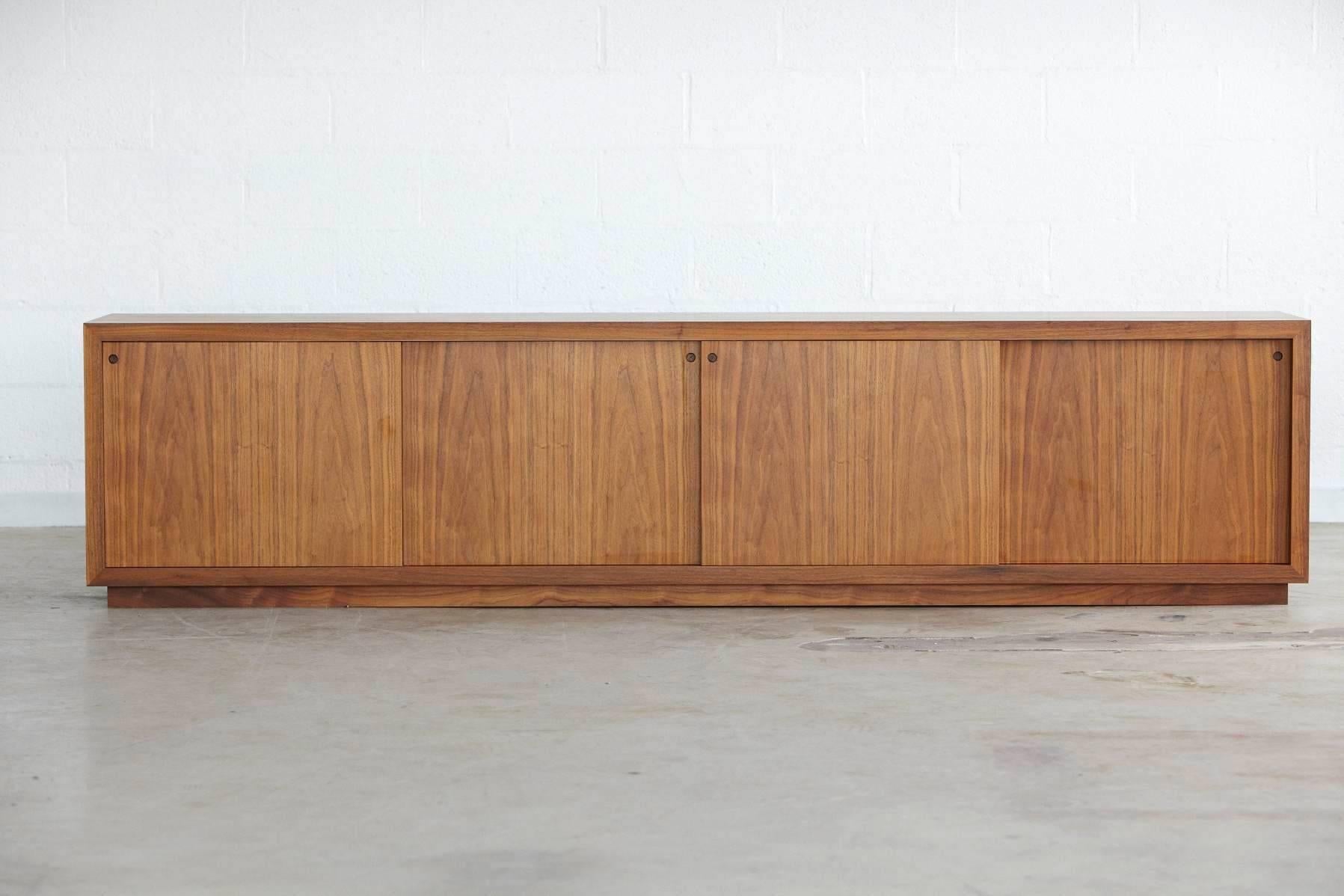 Beautiful minimalistic very long and low sideboard in the style of Ib Kofod-Larsen. Extraordinary craftsmanship.