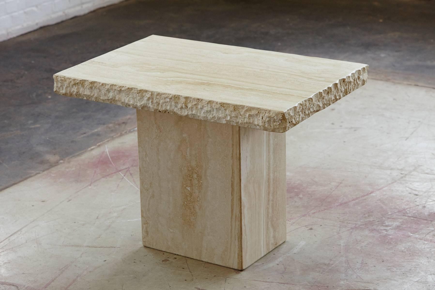 Small side or end table entirely in travertine both base and top. The sculpted rough edges of the top are in a unique contrast with the polished surface and base. Excellent condition.