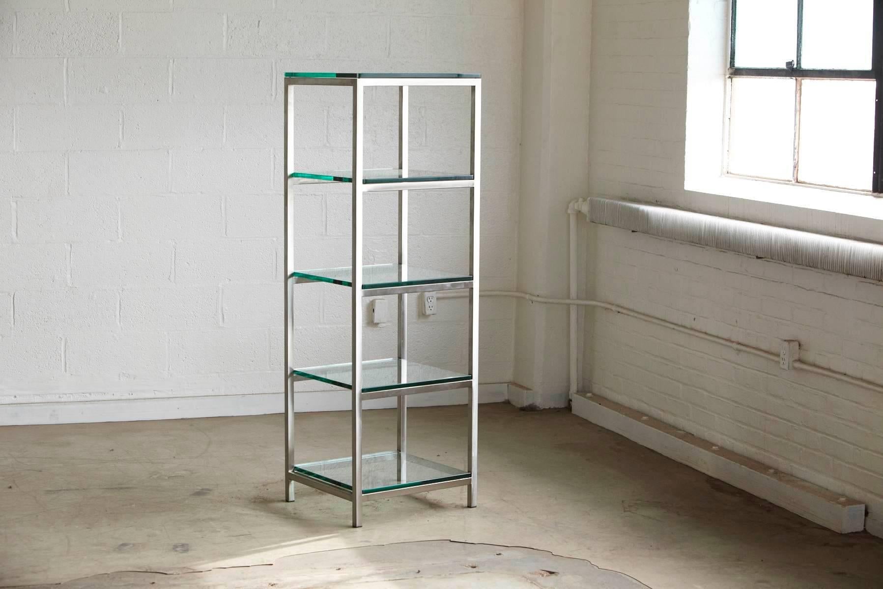 Modern brushed aluminium tube construction with 5 x 3/8 thick glass shelves.
Sturdy and solid appearance caused through the heavy glass shelves.
One of the glass shelves has a minor chip and loss of glass on the corner, which will not be visible