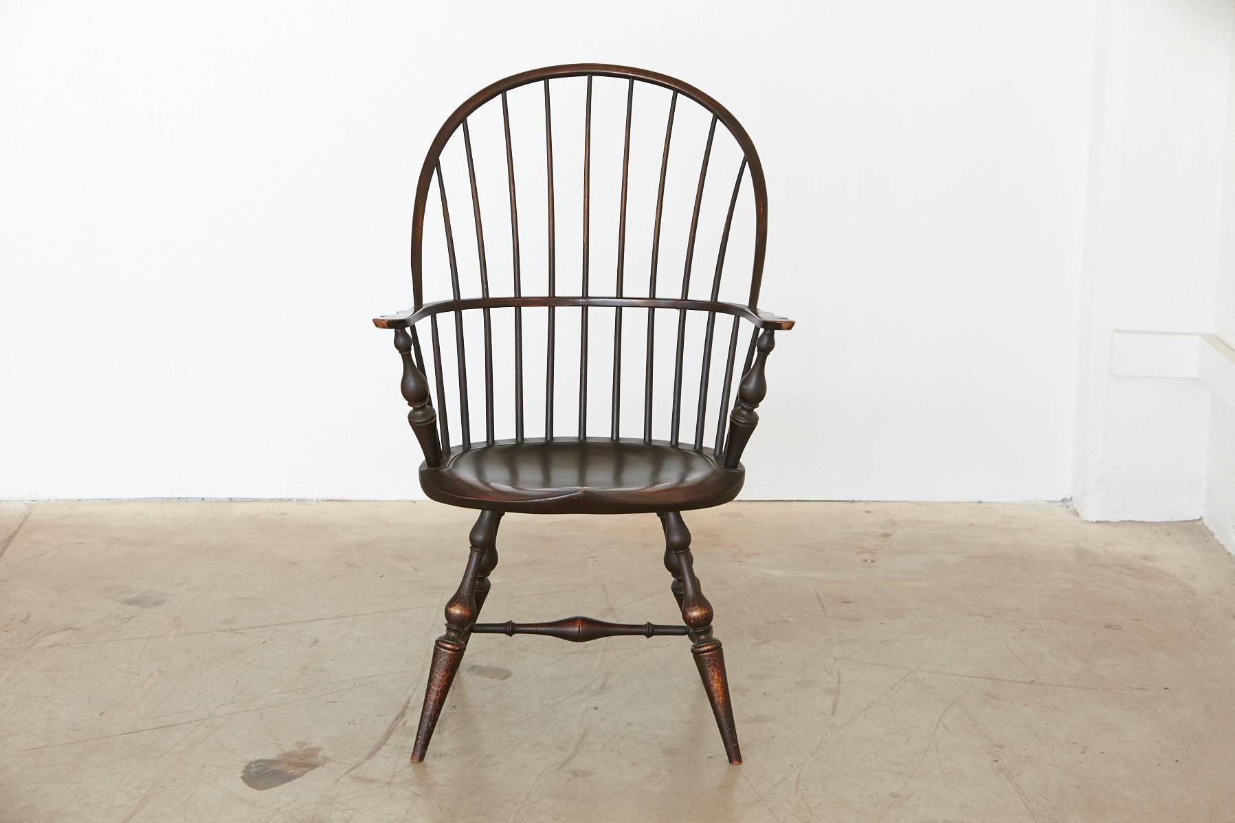 Vintage maple bowback Windsor armchair finished in black crackle. This chair from the 1960s was manufactured by the American furniture company D.R. Dimes.
Dimes have a long history in crafting museum quality reproductions of American furniture.