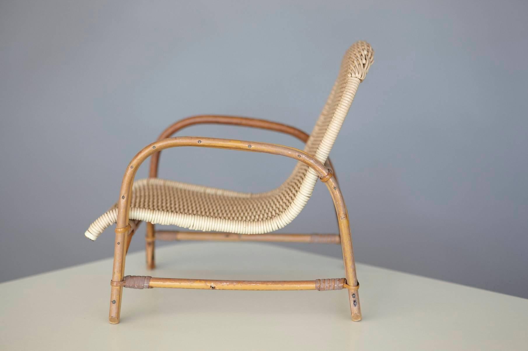 Rare miniature model of a 1960s wicker lounge chair. Rattan base with woven wicker seat.