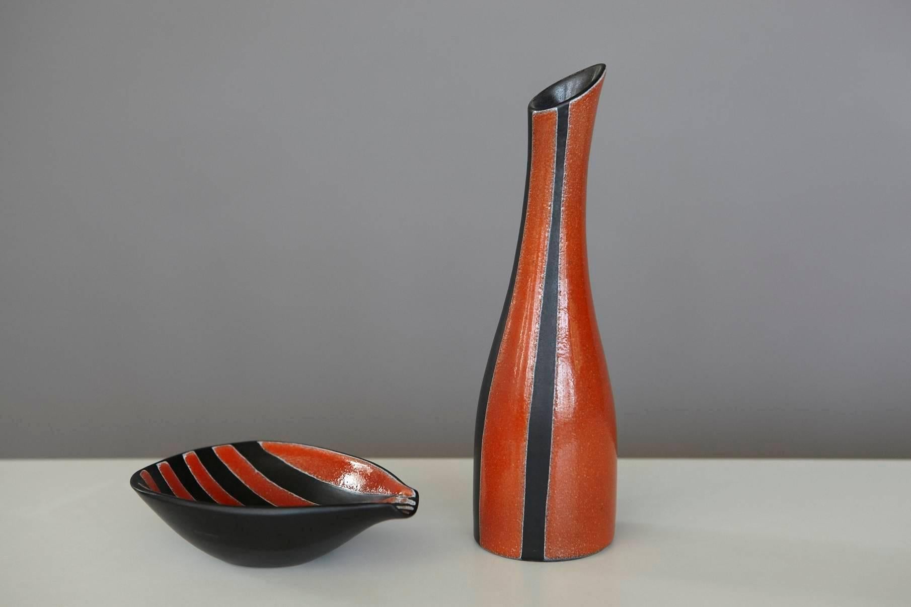 Beautiful set of a matching red and black striped ceramic vase and ashtray by 
ceramic studio Müller Luzern, Swiss Made, circa 1960s.
The vase has a small chip on the upper part of the lip.
Dimensions vase: H 9 in x D 2.65 in.
Dimensions