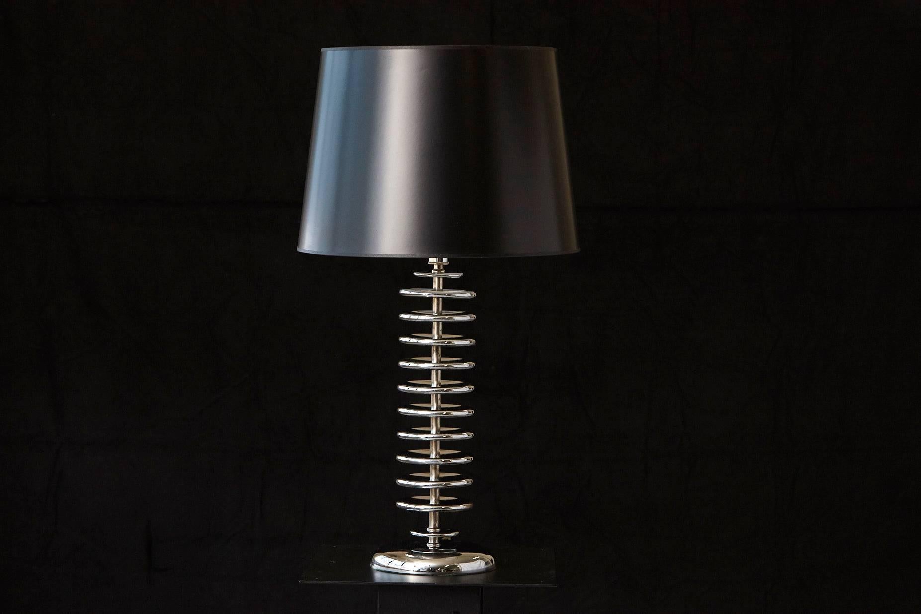Eye catching stacked chrome disc table lamp with new black or silver lining shade. Chrome is in excellent condition.
Height to finial 33.5 in.