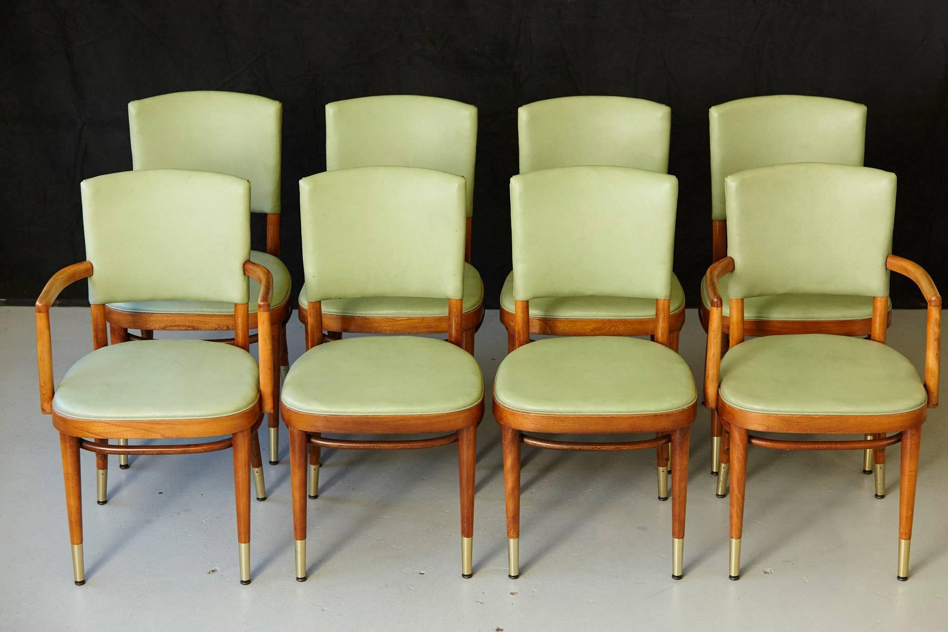Stunning set of eight Thonet maple bentwood chairs covered in a pastel green vinyl and with brass sabots on the legs.
The vinyl is in excellent condition no tears the vinyl. The brass sabots are in great condition as well.
Lots of details in the