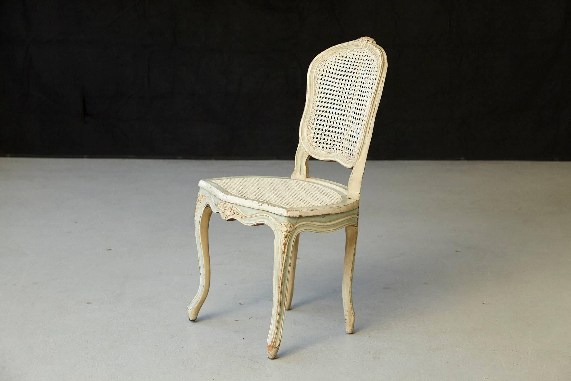 Lovely 19th century paint decorated vanity chair with cane seat and back. The cane is in great condition. Decorative carved floral elements and Classic Louis XV curved legs in sturdy condition.