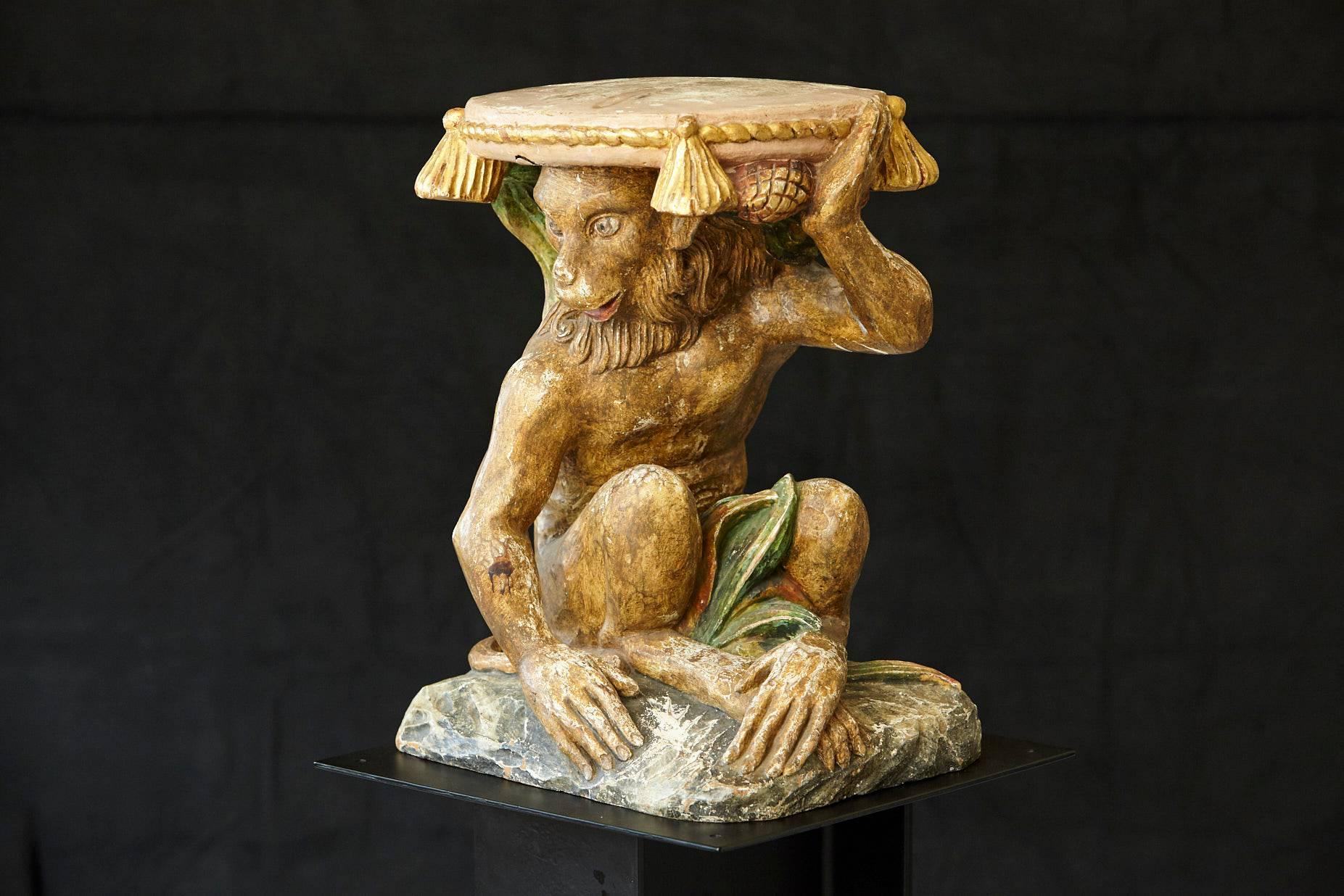Early 20th century carved wood and hand-painted plaster side table with a molded top in form of a pillow on a figural base carved as a monkey sitting on a rock.
Great patina with minor losses, please refer to pictures.
 