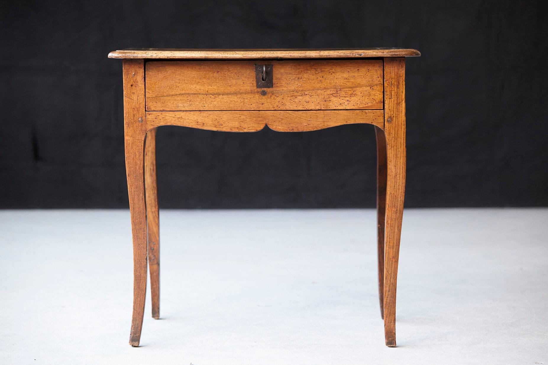 Beautiful small antique French Louis XV style provincial walnut side table, featuring one drawer raised on cabriole legs. Having some restoration to the top.
  
