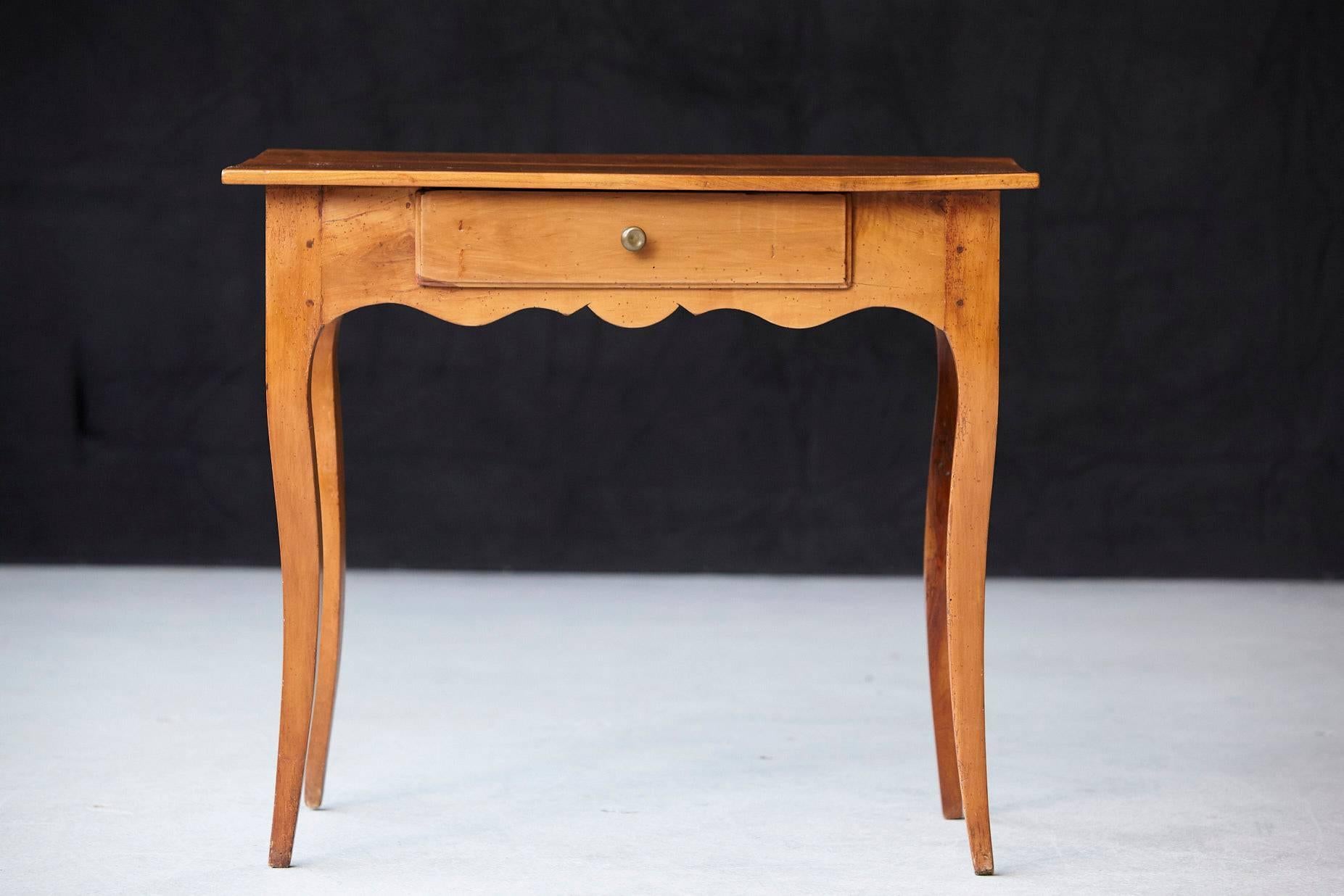 Charming French Provincial fruitwood occasional table, circa 1890, featuring a single drawer, shaped apron and raised on cabriole legs.
 