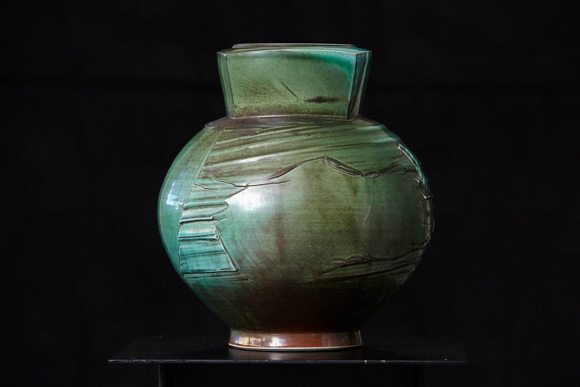 Large, heavy thrown and hand built jar in an exceptional mottled green with a textured surface. Bulbous footed body and paneled neck. Signed on the bottom.
Opening 4.5 in

Chris Staley one of the foremost contemporary American potters, Head of