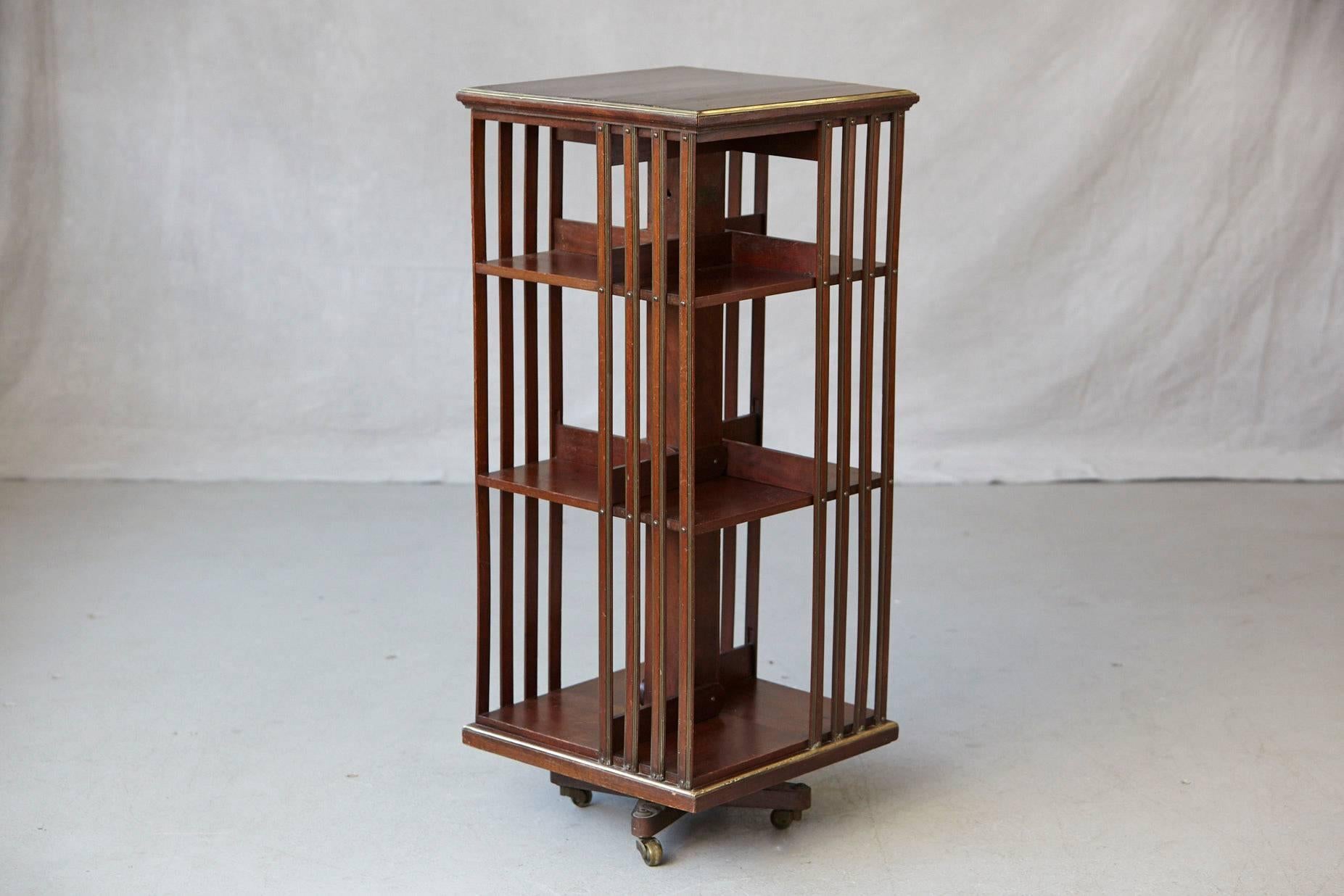 Late 19th Century Antique French Revolving Mahogany Bookcase on Raised Casters with Brass Trim