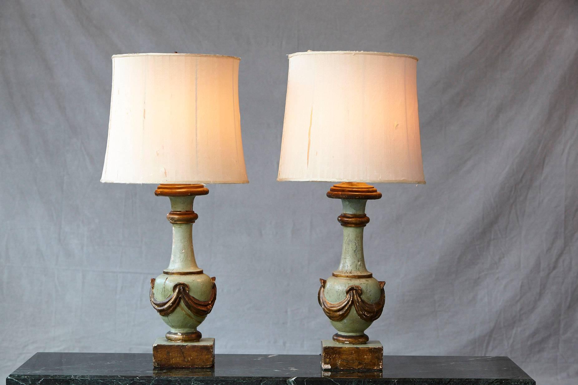 Exceptional pair of antique Italian hand-painted and hand-carved wood variform table lamps, each with an aqua and guilt finish. The draped bottle forms on squared bases. custom-made silk shades.

The lamps and shades are as is, with splits in the