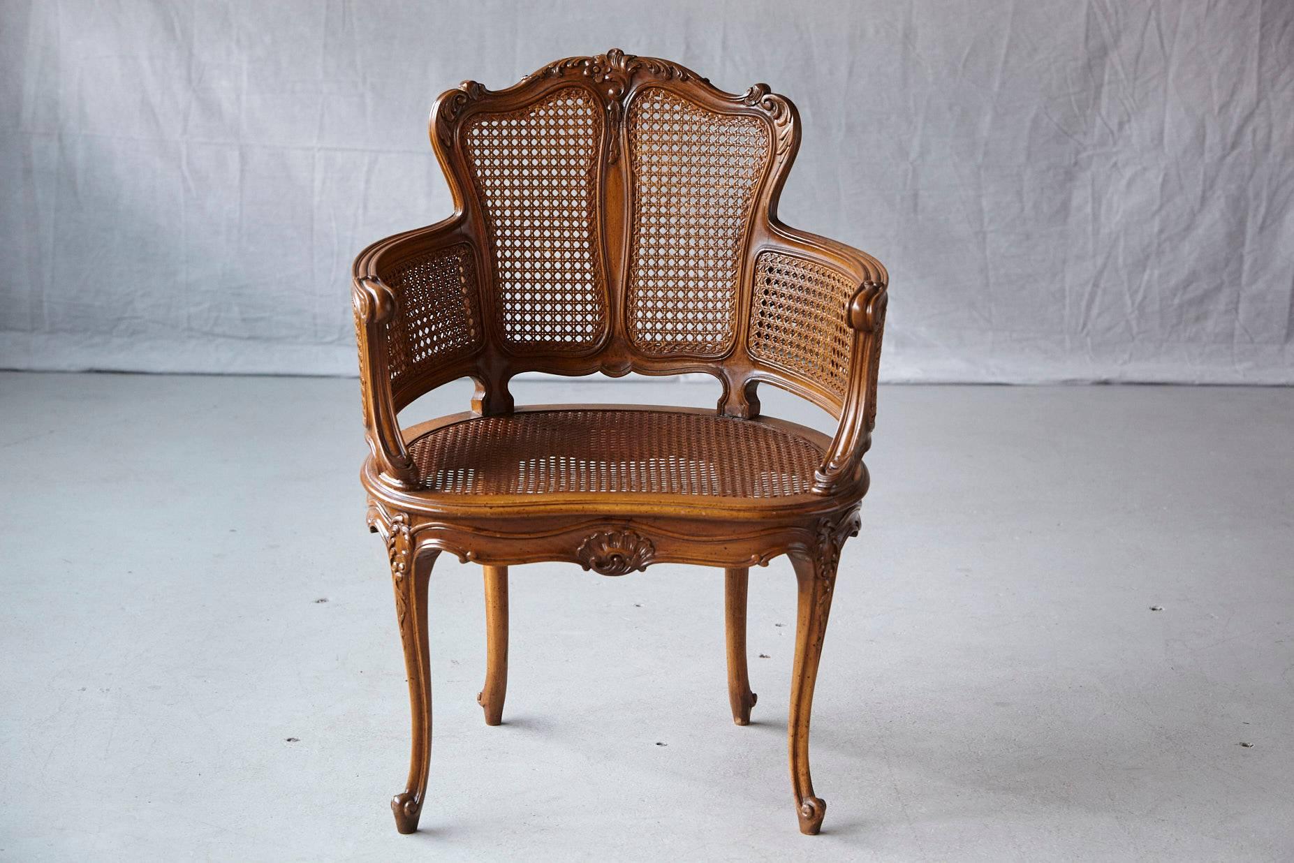 Early 20th century Rococo style caned armchair with elaborated ornamental acanthus leaves carvings, double caned arms, raised on cabriole legs.
The cane is in very good condition, some flaking to caning finish.
 