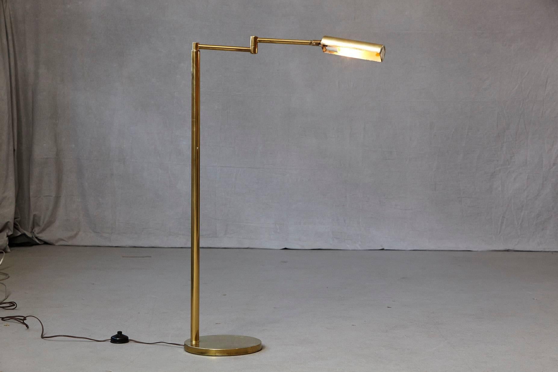 Height adjustable brass swing arm pharmacy floor lamp by Koch & Lowy.
Measure: Height from 41.5 in to 51.5 in
Some minor scratches to the round brass base, otherwise great patina. 
 