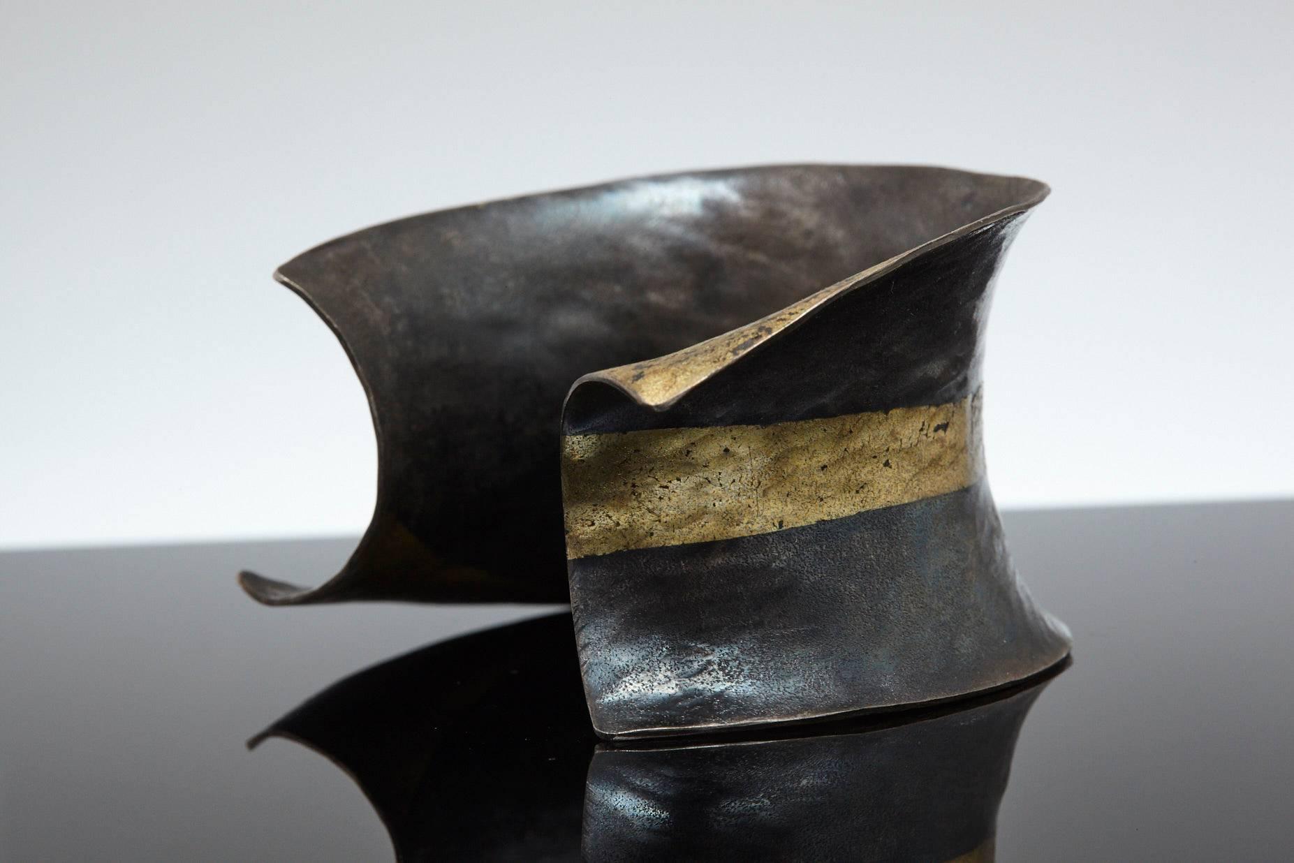 Exceptional hand-forged blackened iron fused with 22-karat gold cuff in the style of Pat Flynn.
As the piece is worn, the black iron lightens to a gorgeous gray.
Inside length 2.24 in, inside width 2 in, opening gap 1.25 in.