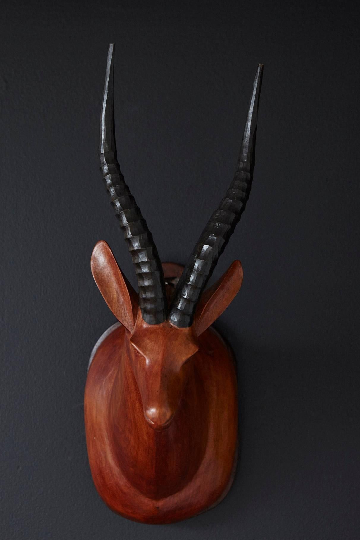 A nice alternative to the typical antlers, a midcentury hand-carved antelope wall mount.