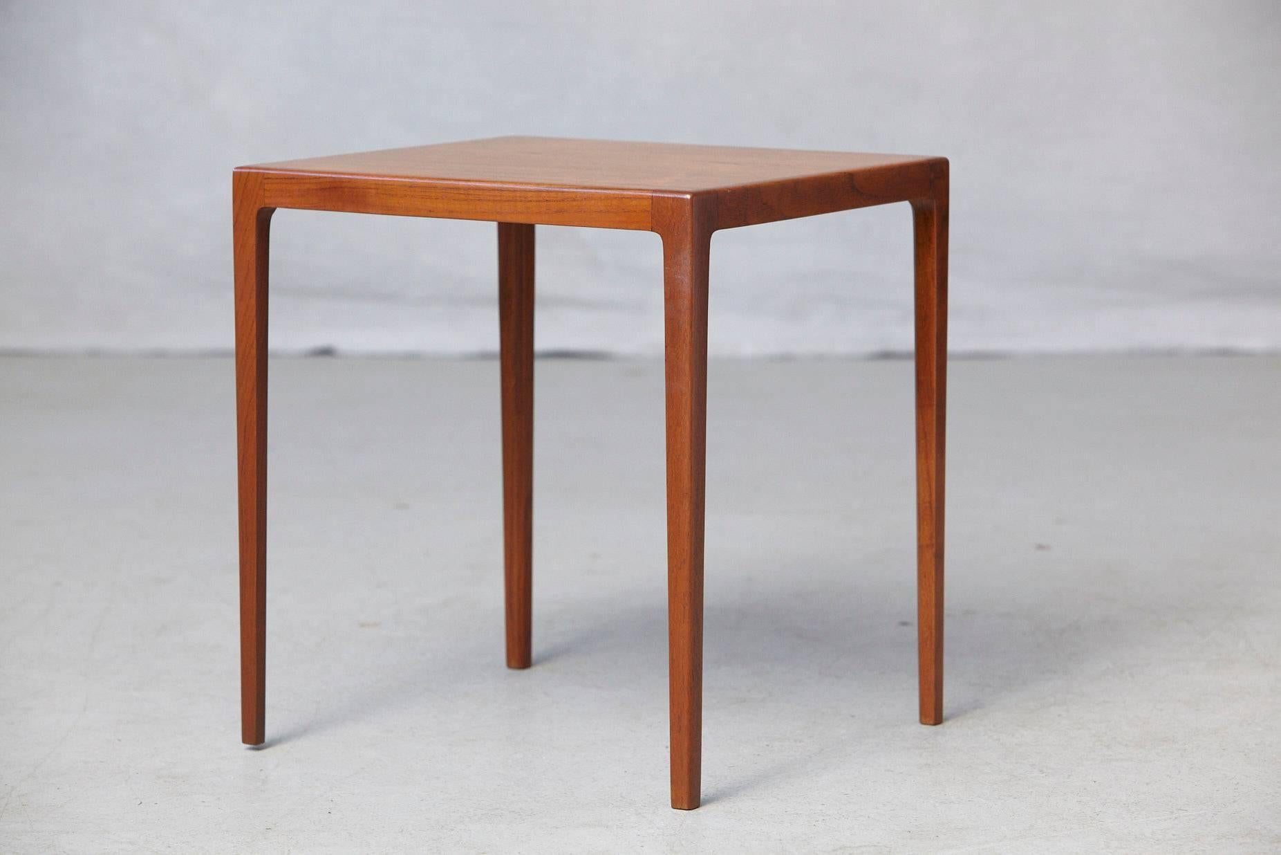 Lovely midcentury Danish solid teak side table by Ludvig Pontoppidan. Beautiful sleek design with long tapered legs which end smoothly into the corners of the table. The table has been completely newly refinished in November 2017 and has a very