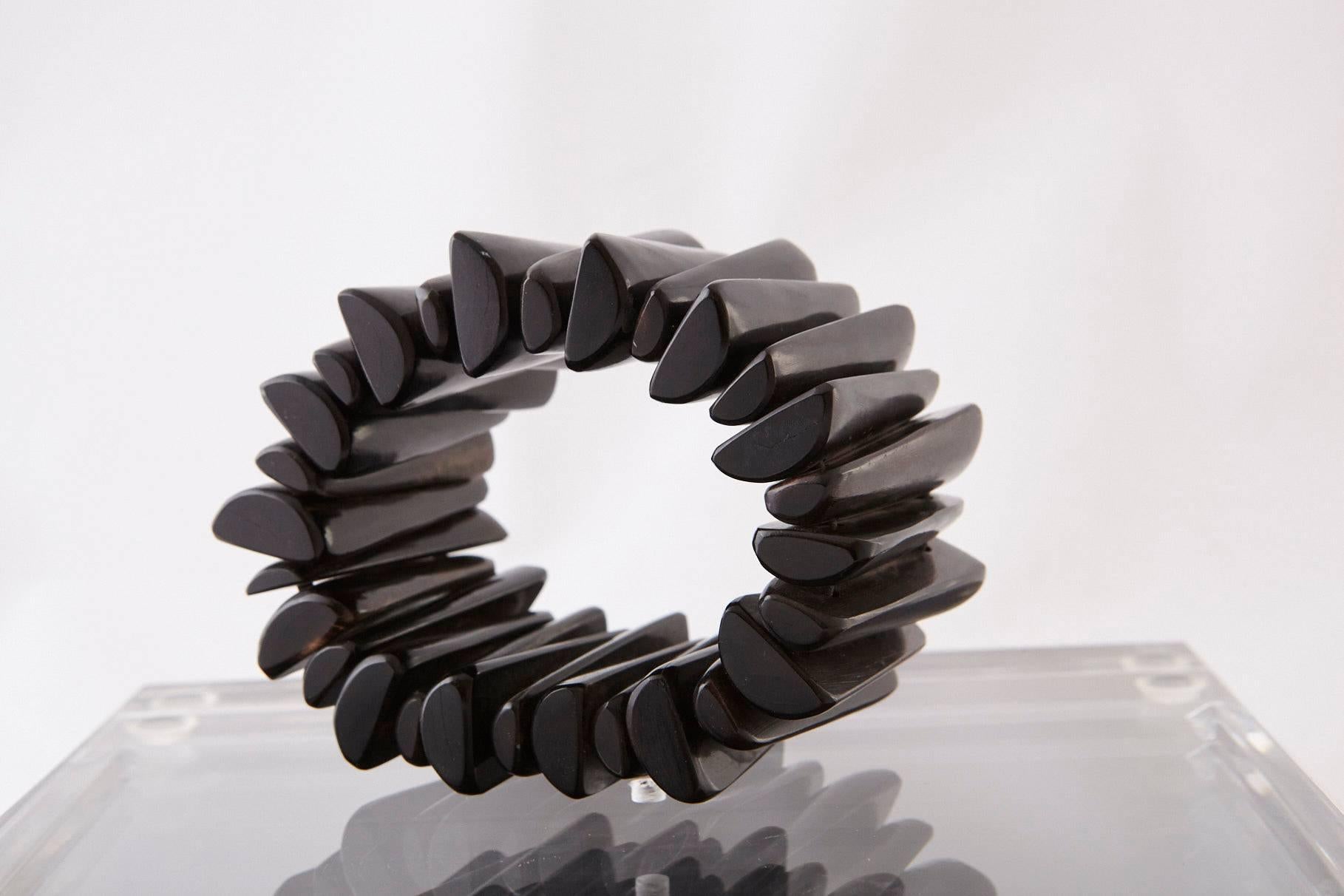Stunning large modern hand-carved ebony bracelet made from 28 single pieces of ebony.

Measure: Opening 2.25 inches.