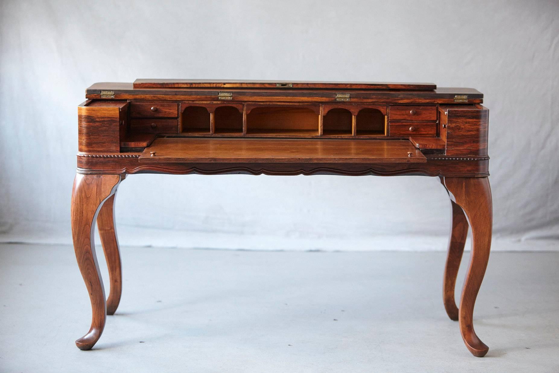 Exceptional late 19th century Queen Anne style Rosewood spinet desk with a myriad of drawers, pigeon holes, and cupboards mounted on cabriole legs with pad feed. 
The desk has been completely refinished, photographed and stored.
Measurements: W 53.5