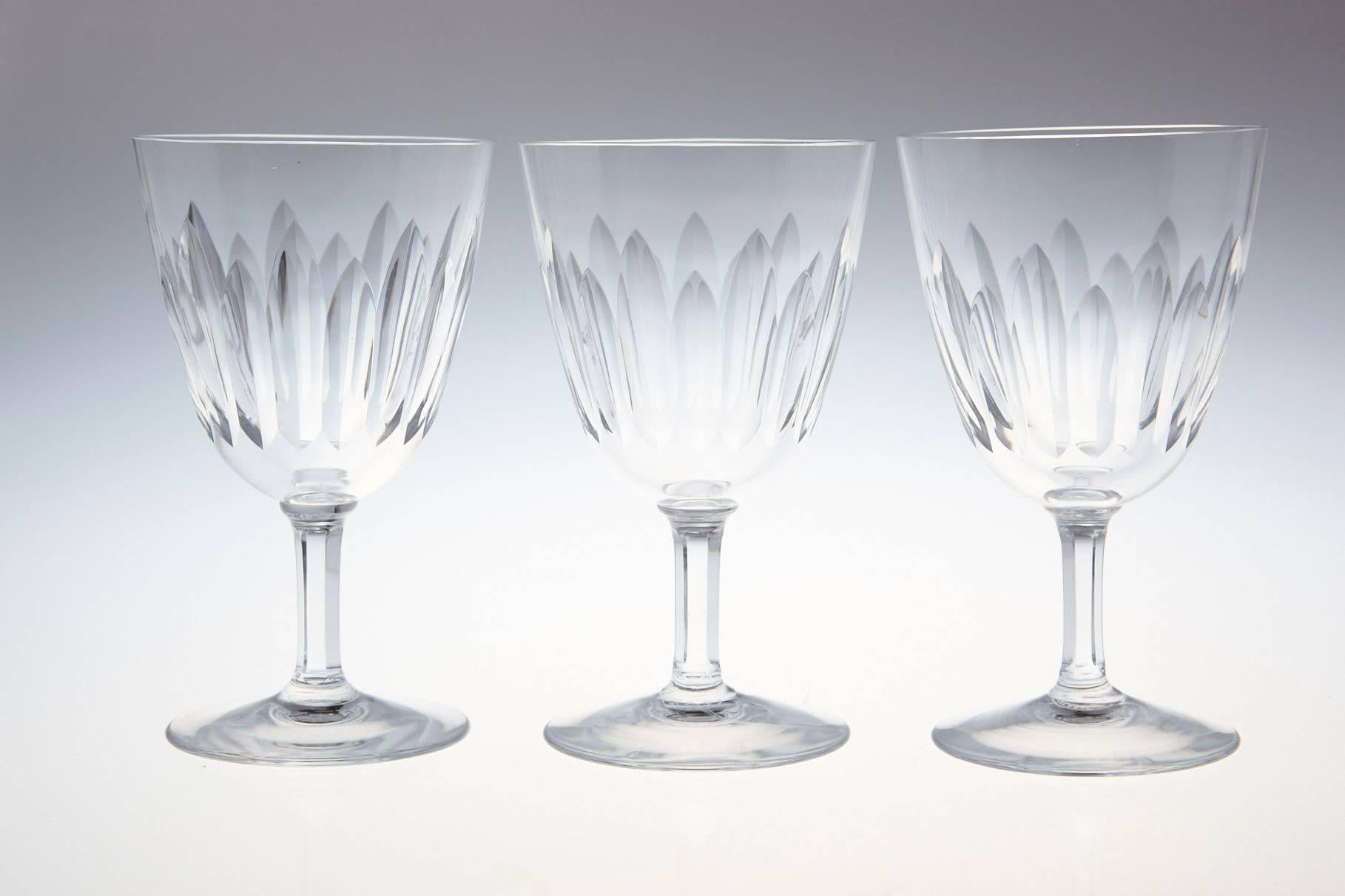 Rare set of eight Baccarat crystal white wine glasses in the 'Verone' pattern. The glasses are in a vertical cut bowl form with a six sided stem. This pattern was manufactured between 1954-1961.
The glasses are in a very good condition.