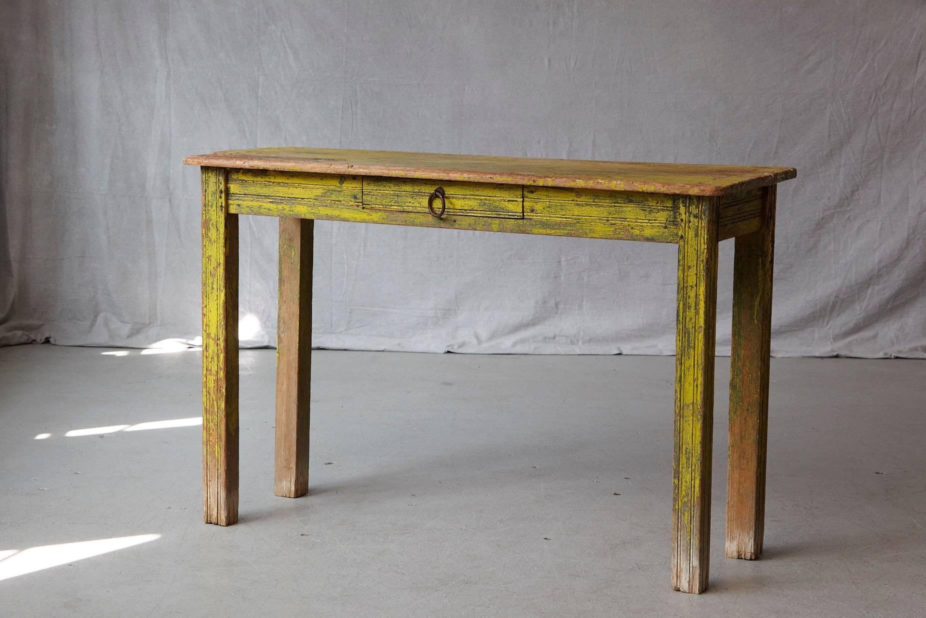 Primitive yellow-painted console table with drawer in a distressed, very much Wabi Sabi style appearance. 
Good and solid condition, with a very nice patina.
  