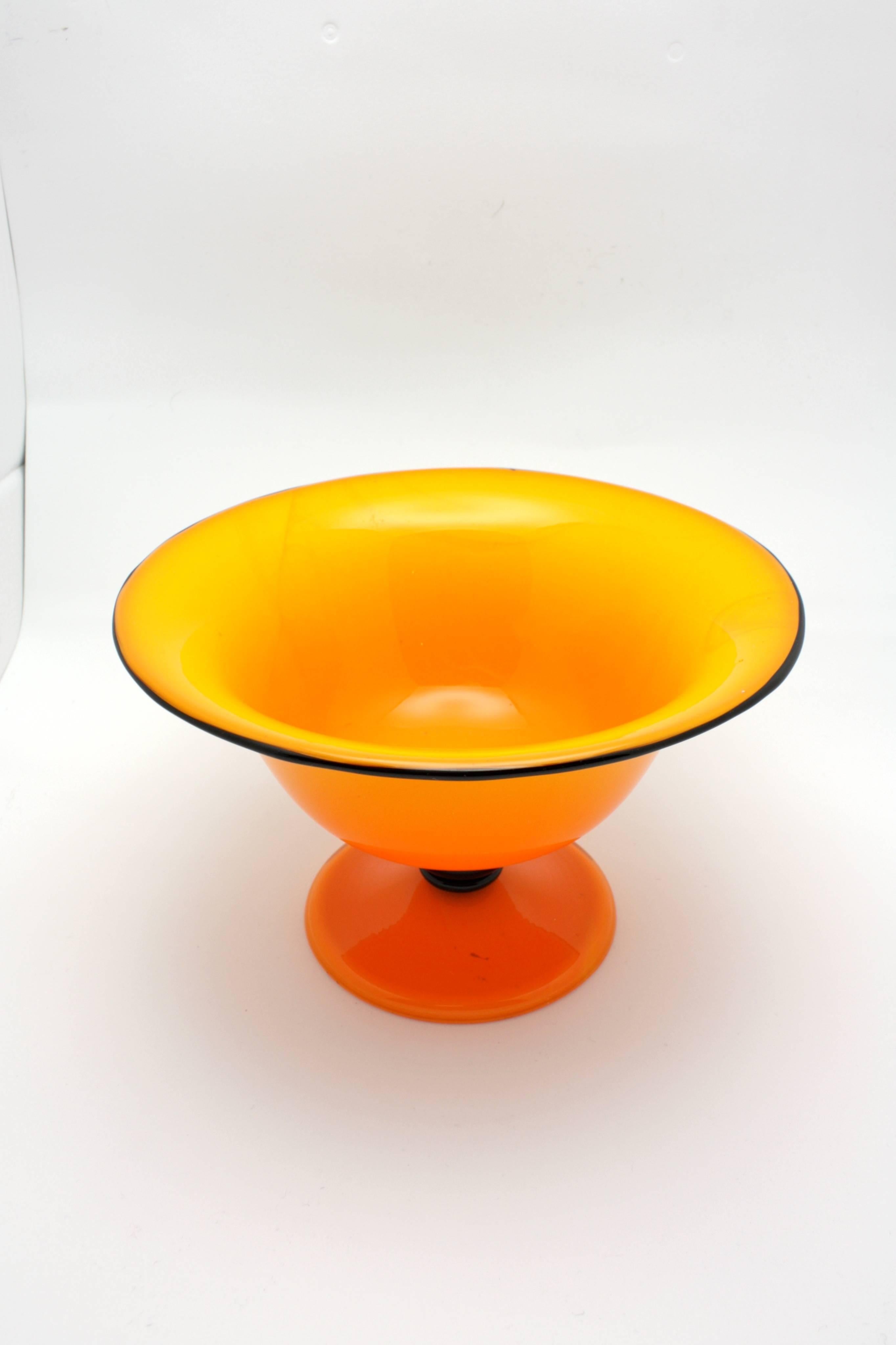 Michael Powolny (Austrian, 1871-1954) a Loetz bowl. 
Clear cased glass over orange with a solid black rim and raised on a black glass triple stem band. 

