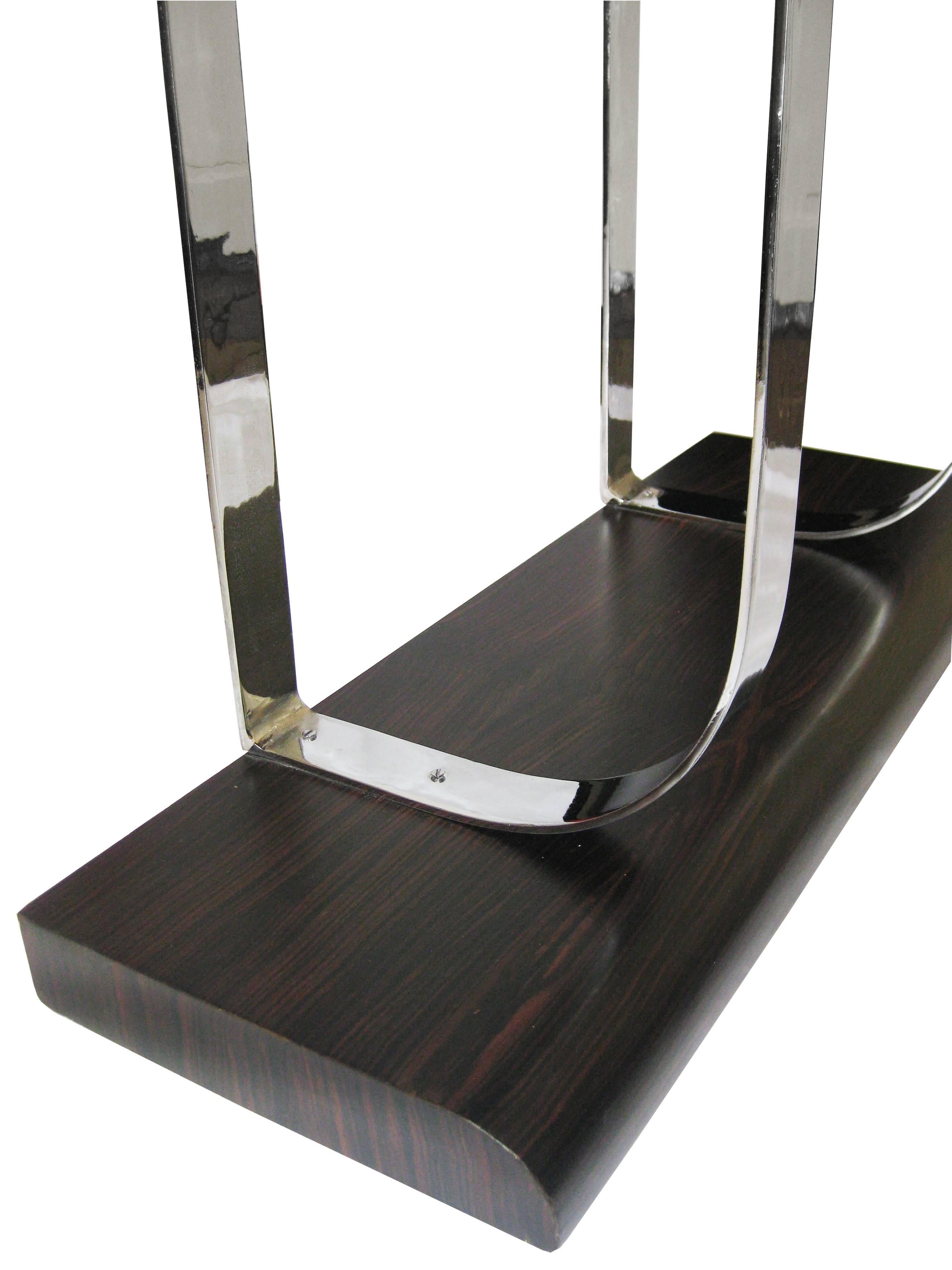 Console veneered in ebony with a chrome base, circa 1930.  Simple, clean lines create an elegant piece.
