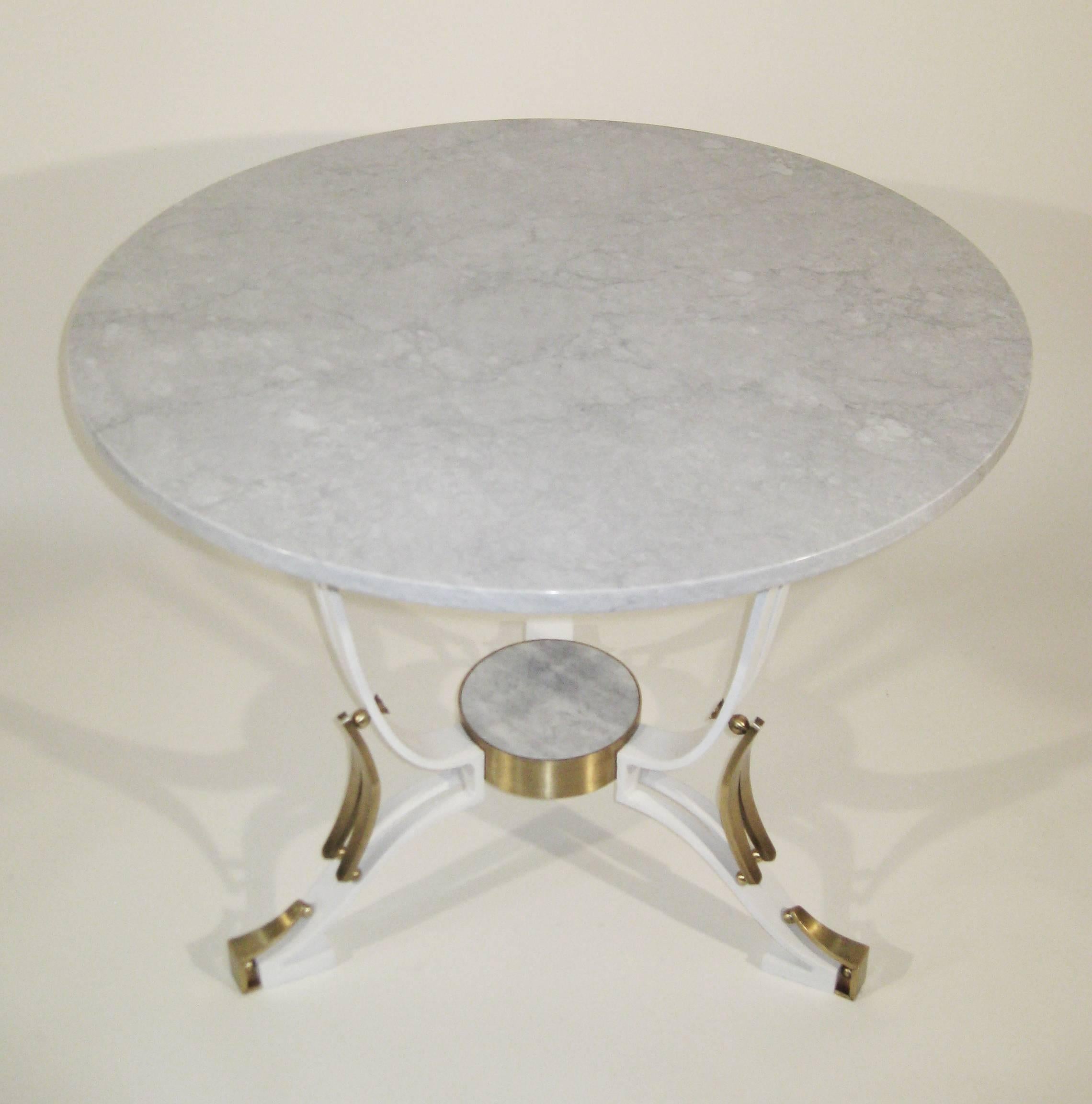 With an unusual white lacquered finish, this substantial yet light and elegant table is finished off with bronze flourishes and a white Carrara marble top, circa 1940.

Born in France, Roberto y Mito Block emigrated to Mexico in the late 1930s.