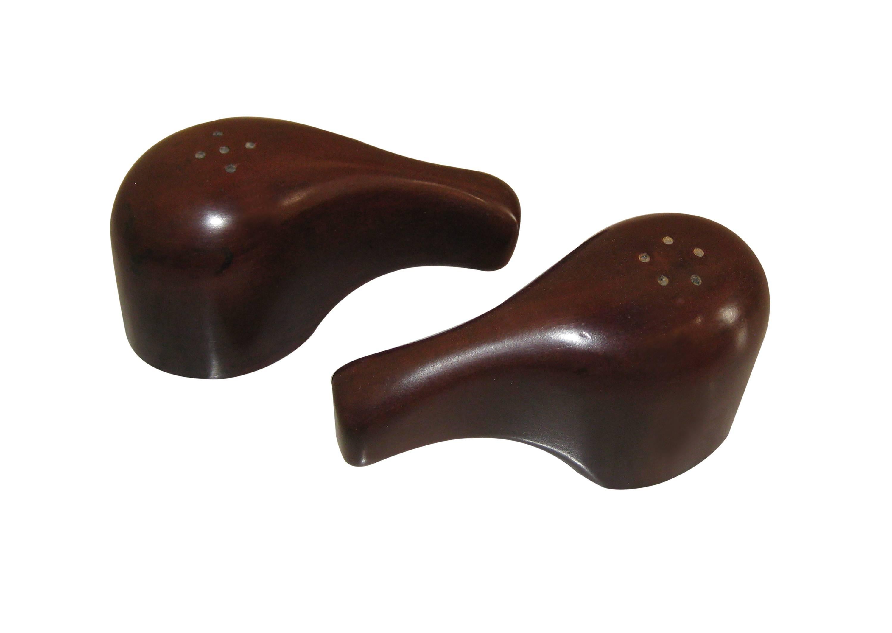 The smooth silhouettes of these salt-and-pepper shakers are both elegant and effortless to hold. That is, they are easy on the eyes as well as on the hands! With cork stoppers and a purely organic flair. In pristine condition.

Don Shoemaker