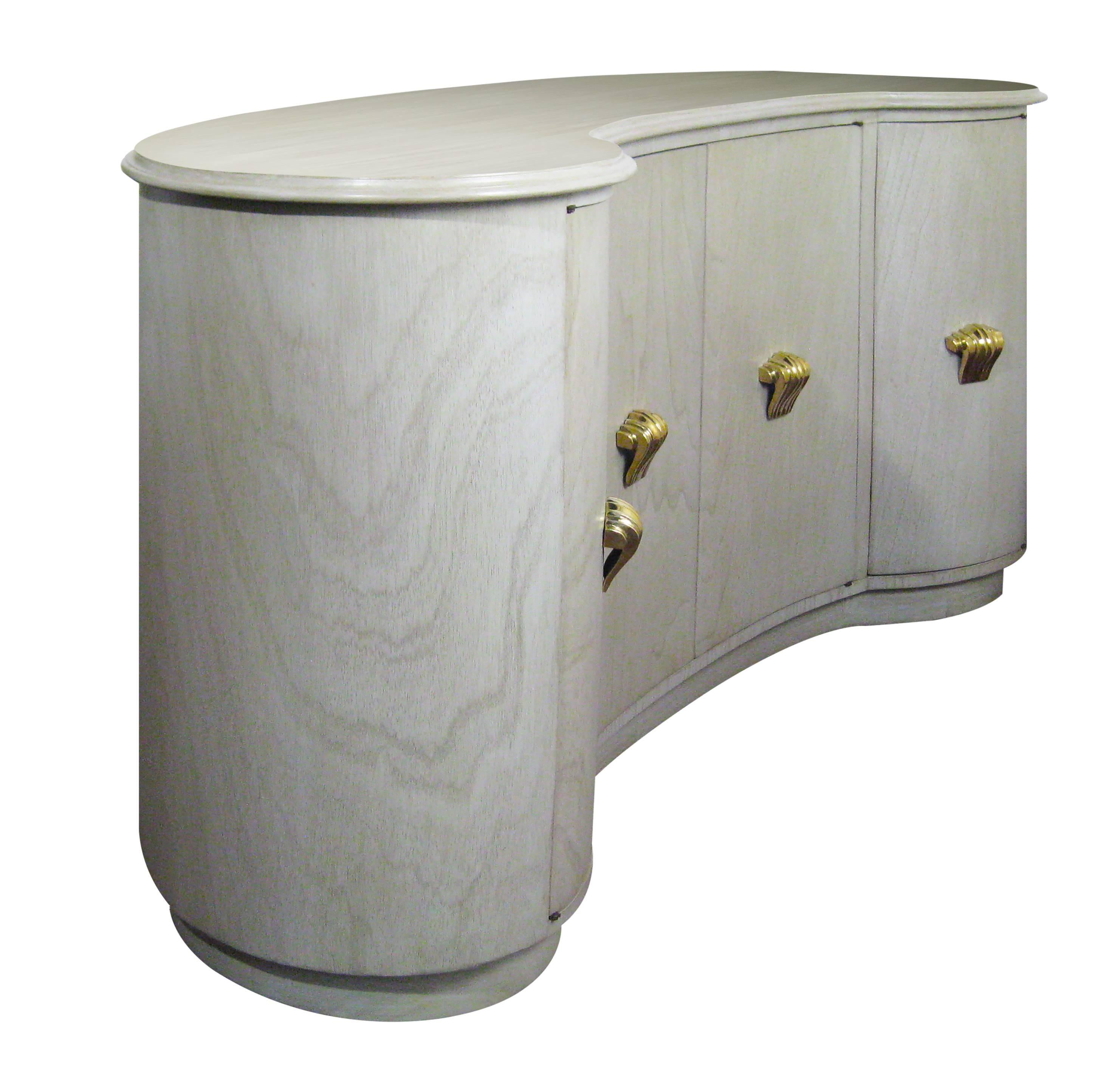 This charming buffet constructed in a delicate curve can (and should!) be exhibited from all angles. The finish is a cerused or 