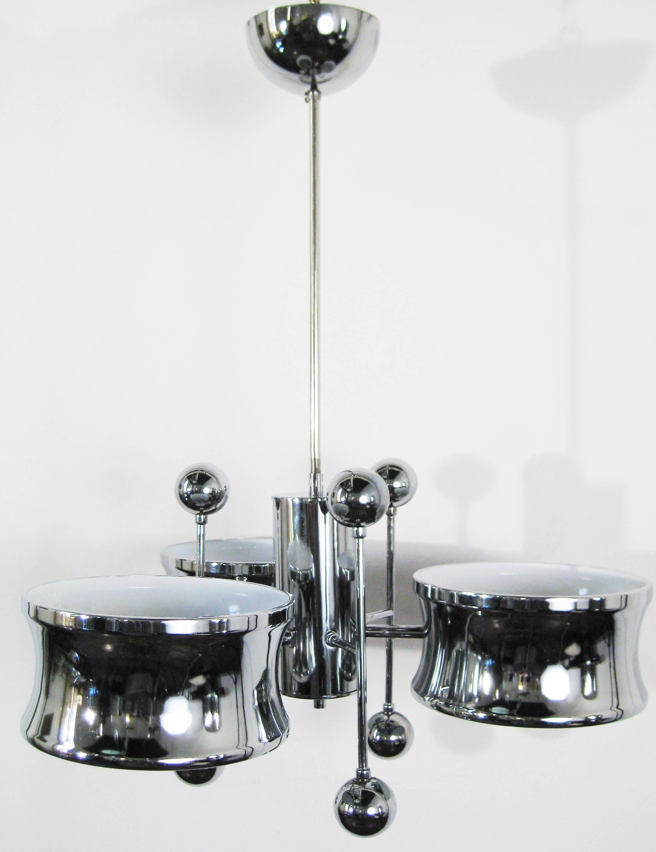 This unusual lamp is from the time period when the designs of Gaetano Sciolari were produced by the upscale American company Lightolier. The chromed arms are crowned by wonderful chromed spheres. Whimsical and yet so very tasteful. A lovely,