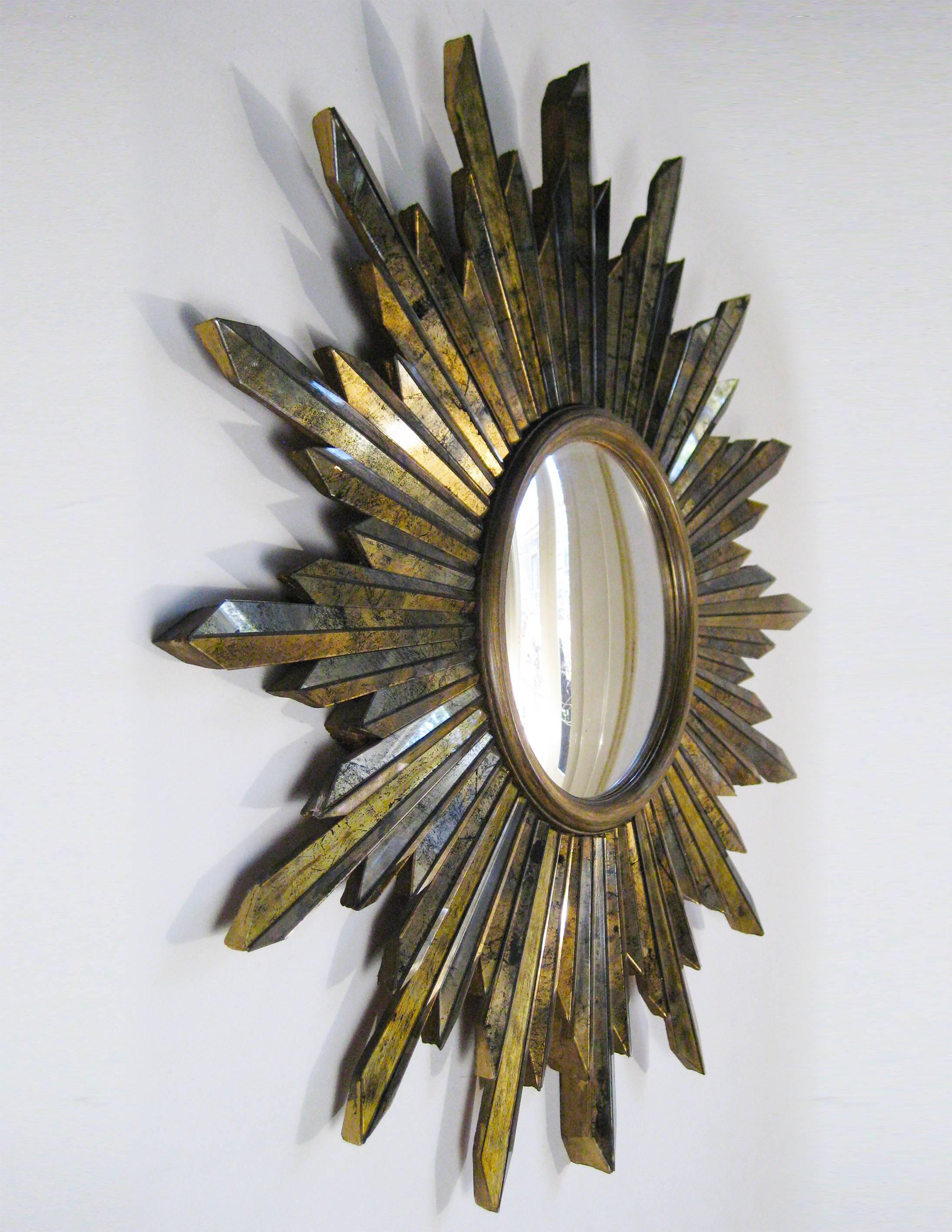 This large, quite spectacular convex sunburst mirror is fashioned from a heavy wooden, quite intricate frame, and every mirrored 