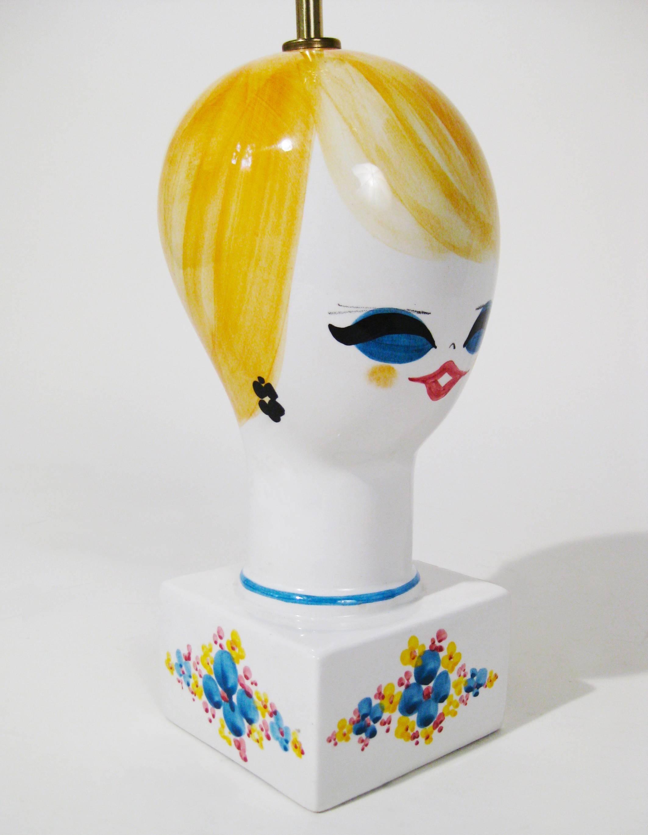 This stylized bust of glazed pottery reminds us of the trends of the late 1960s and early 1970s: black eyeliner, false eyelashes, and eye-catching lipstick. Charming piece that captures not only the fashion trends of the era, but the spirit of