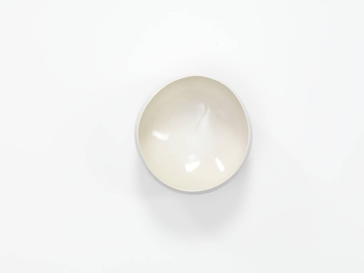 A porcelain bowl with transparent glaze.

By Masamichi Yoshikawa, Japan.

Measures: 7 x 14 cm (2 3/4 x 5 1/2