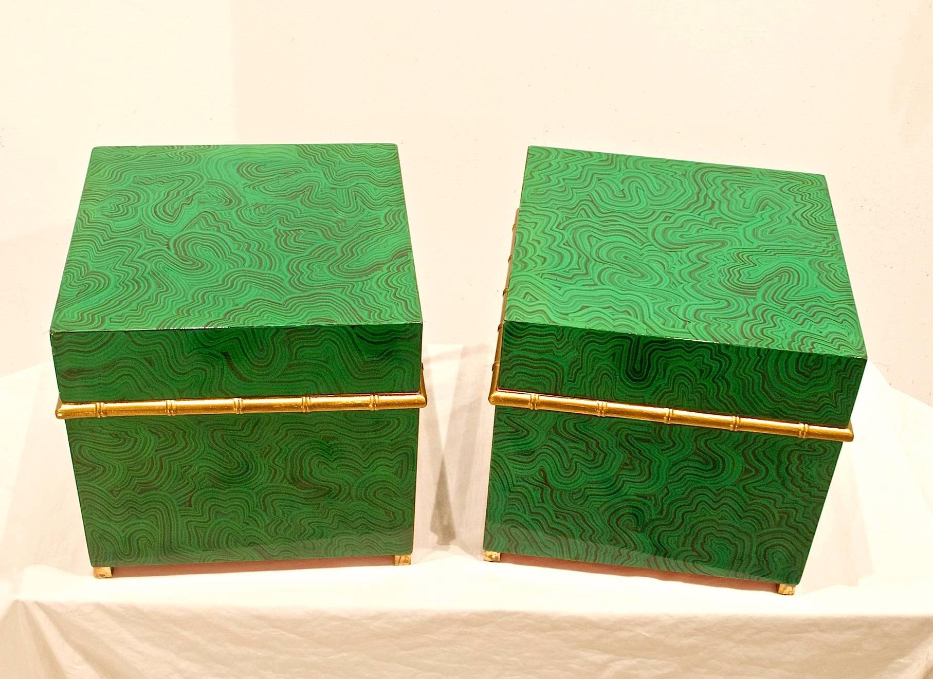 Pair of faux malachite boxes with style to spare. These hard to come by storage boxes can house your finery with panache'. Having faux bamboo trimmings and brass capped feet, these luxurious cubes can do wrong. Salmon lacquered interiors.