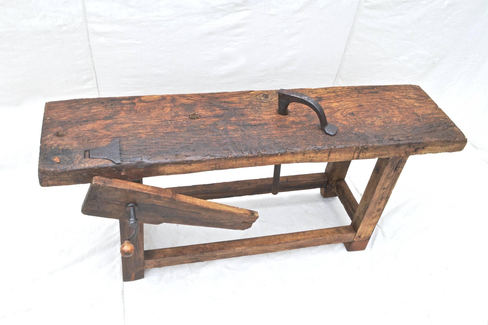 18th century workbench of elmwood. Mortised construction throughout gives this wonderful piece not only strength, but a simple beauty that is difficult to duplicate. Use as a statement coffee table or console. All original and working