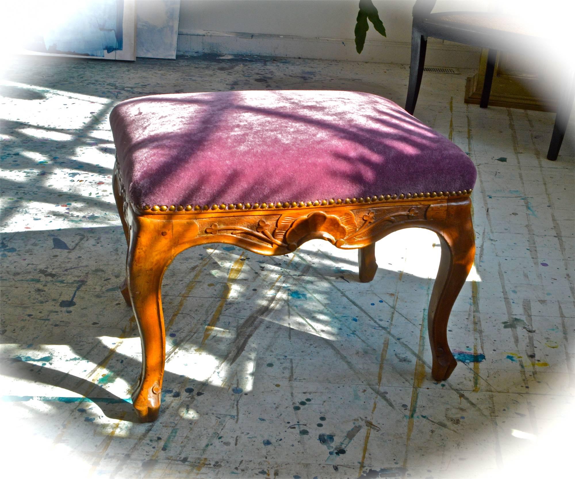 A splendid early-20th century Italian bench of carved walnut dressed up in Pierre Frey mohair. Hand chosen vintage nailhead has been applied all around to complete the luxe look of this fantastic bench. Recently reupholstered and in very good